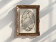 a framed artwork hanging on a white wall, depicting a landscape scene with a tree and flowers.