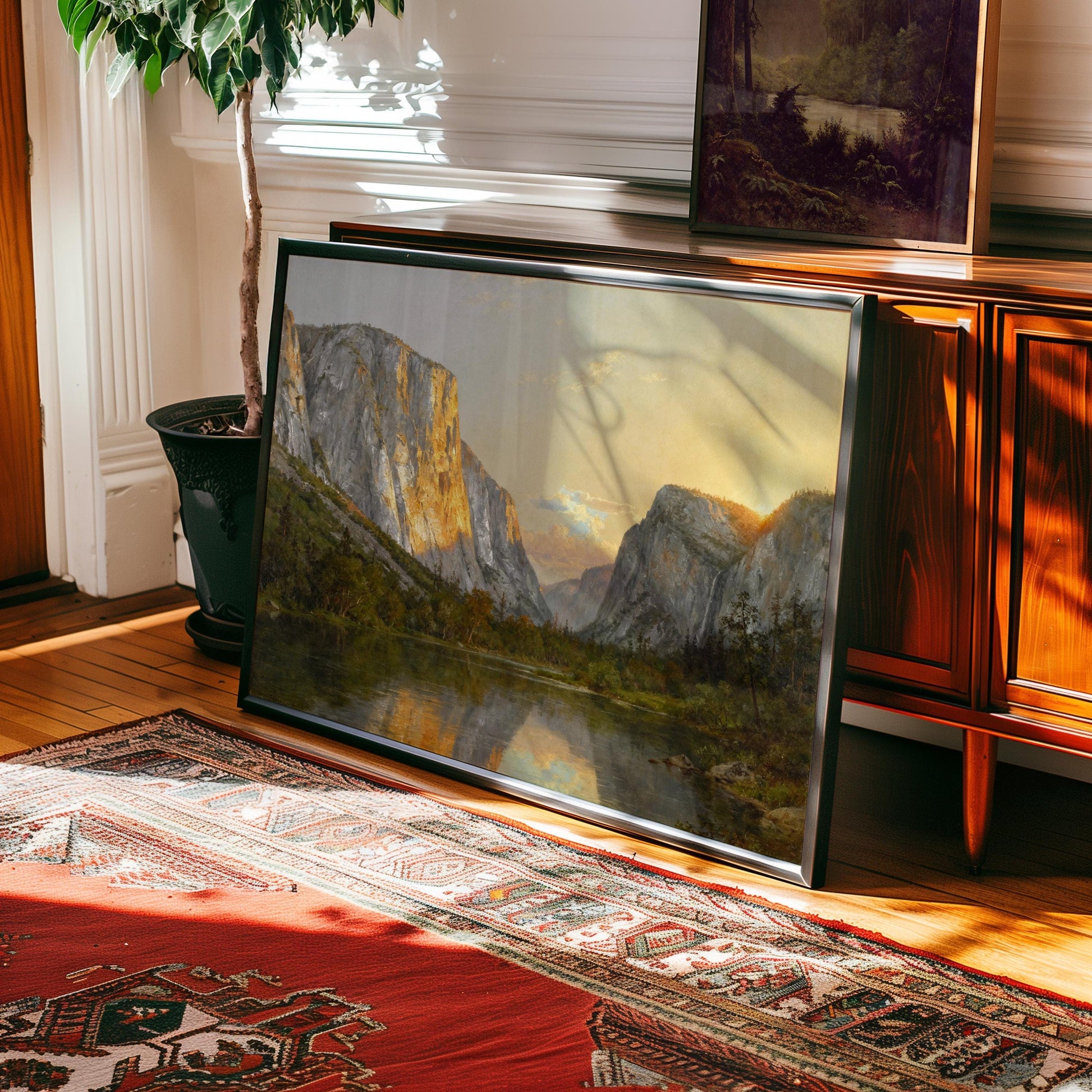 a large framed painting of a mountainous landscape, with a lake in the foreground. The painting is displayed on a wooden cabinet, and there is a rug on the floor in front of it.