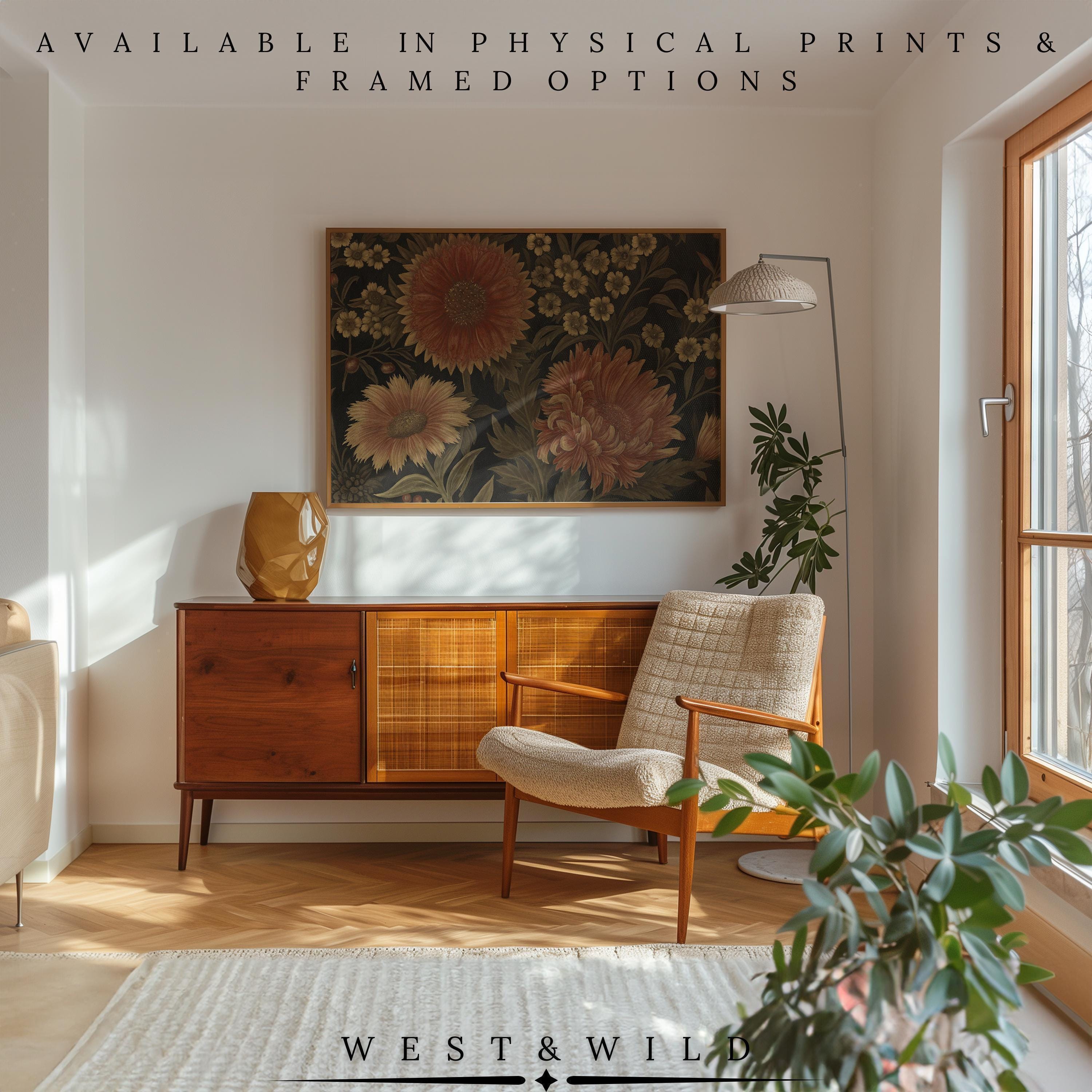 A cozy, sunlit living room showcases a vintage armchair, wooden sideboard, floor lamp, leafy plants, and the Terracotta Flower Painting—Rustic Wall Decor. Find this vintage floral print with frame in the West & Wild Art Archive.