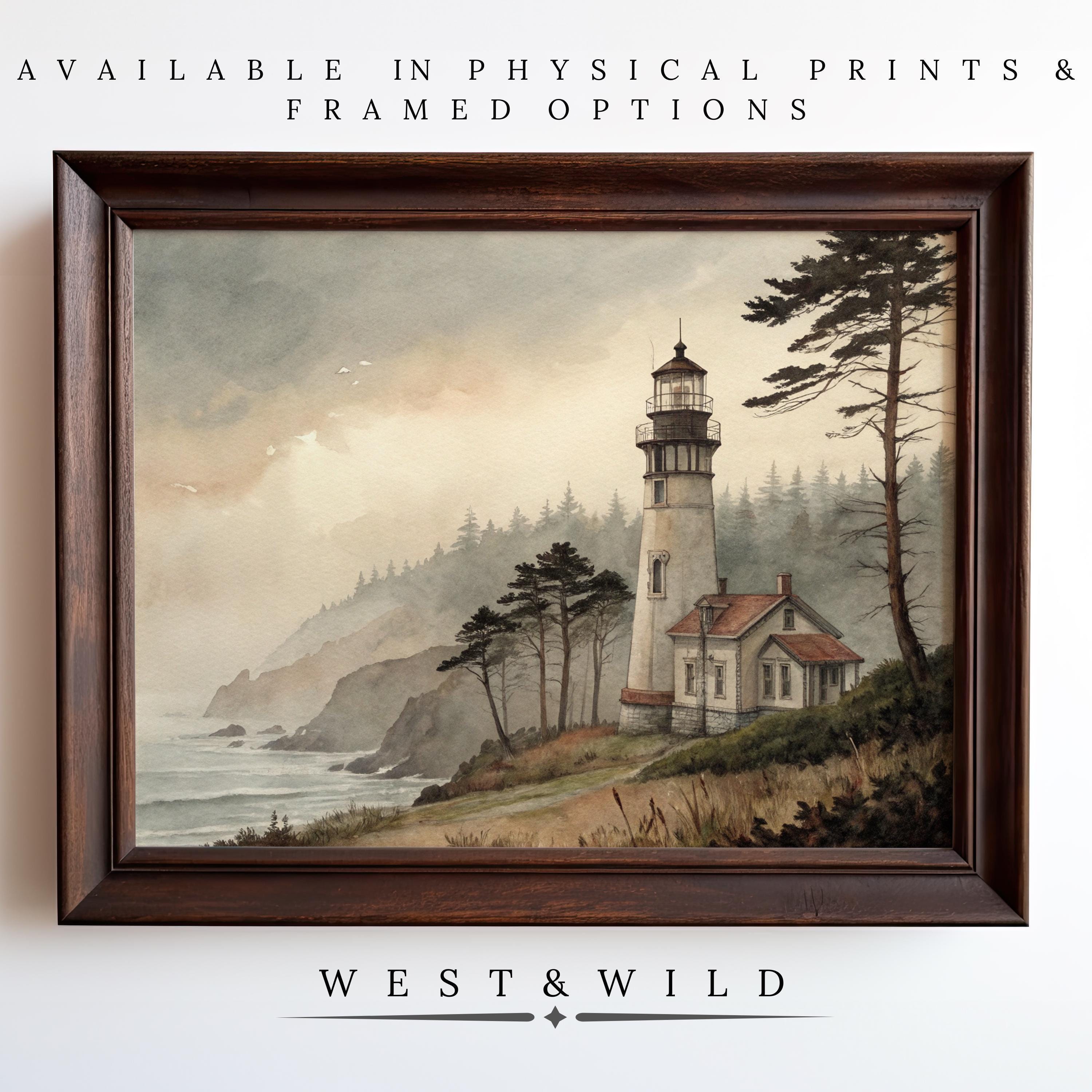 Lighthouse Wall Art – Coastal watercolor lighthouse print featuring a seaside cliff, trees, and misty skies. Vintage art with rustic framing from the West & Wild Art Archive collection. Archival quality ensures lasting beauty; WEST & WILD below the artwork.