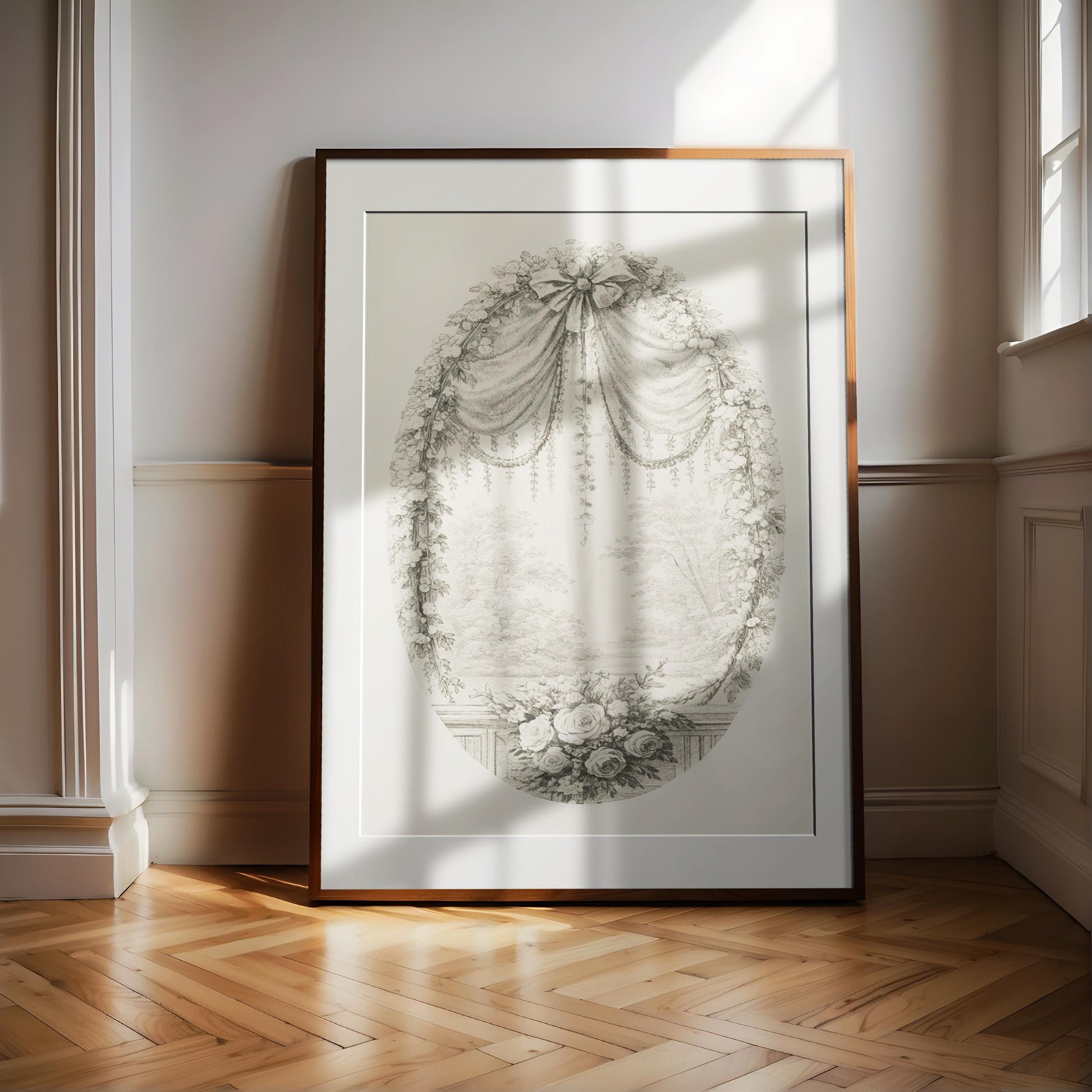 a large, ornate frame with a detailed drawing of a floral design, placed on a wooden floor in a room with white walls.