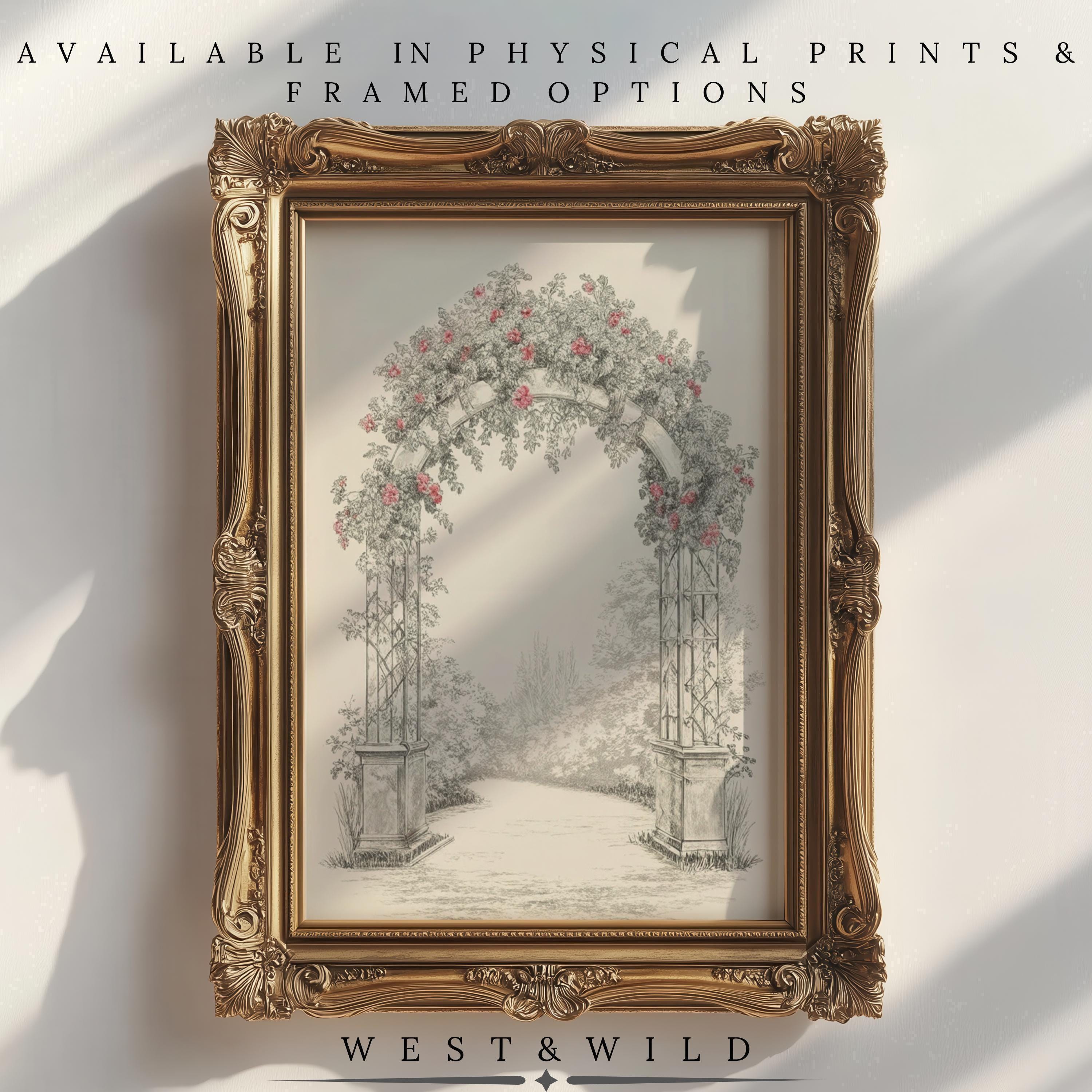 The Vintage Floral Archway Print — Italian Garden Gate Botanical Art features a vintage gold frame, pink flowers, and botanical greenery. Available as physical prints or framed. West & Wild. Sunlight casts soft shadows for added charm.