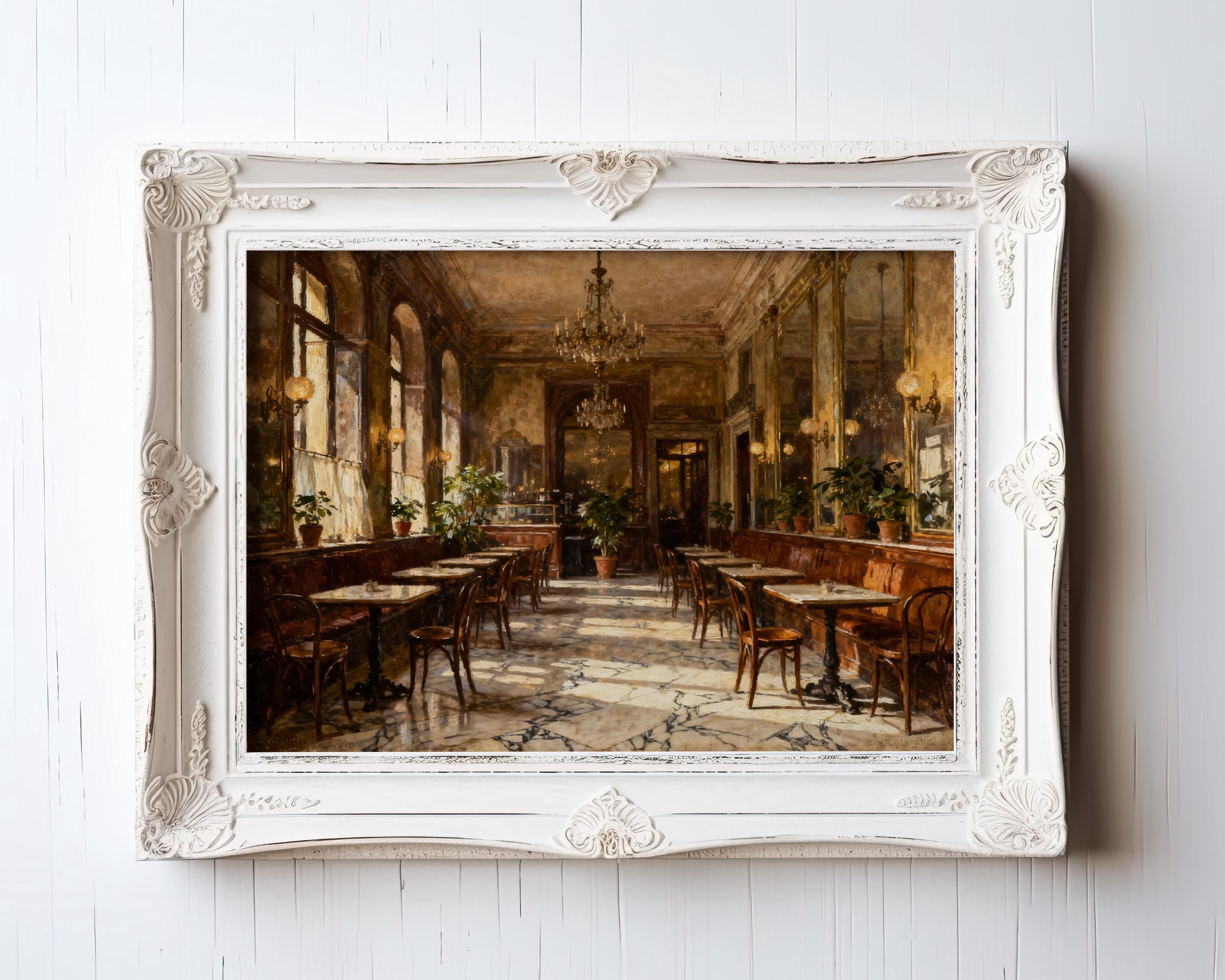 The Vintage European Cafe Print – Classic Marble Floor Art with Warm Light & Chandeliers from West & Wild is displayed on a white wall and printed on archival quality paper for lasting beauty.
