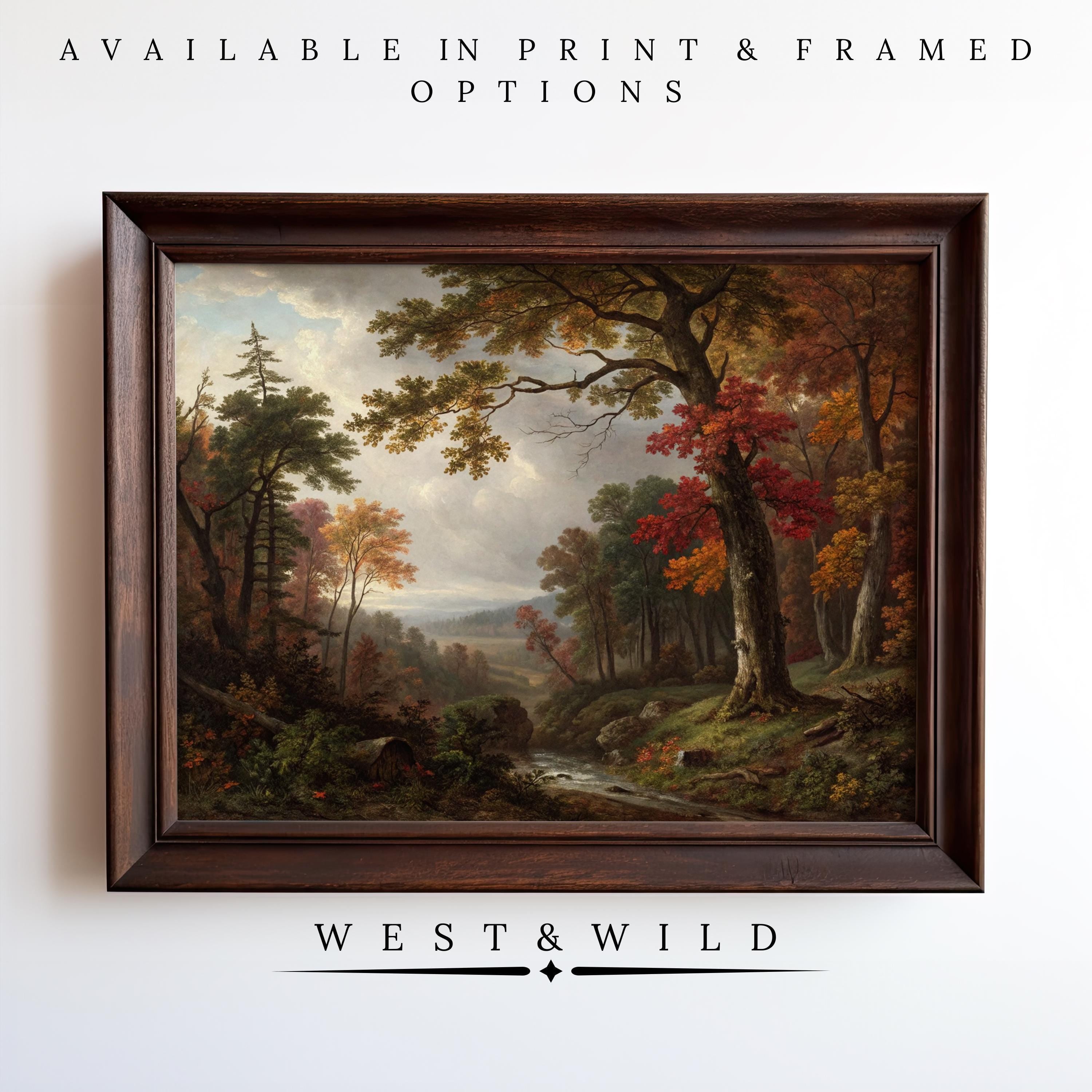 A framed Autumn Forest Wall Art – Vintage Forest Poster with colorful trees and a stream hangs on a white wall. Above is "Museum Grade Print & Framed Options," below, "West & Wild" – rustic wall decor from our vintage art prints collection.