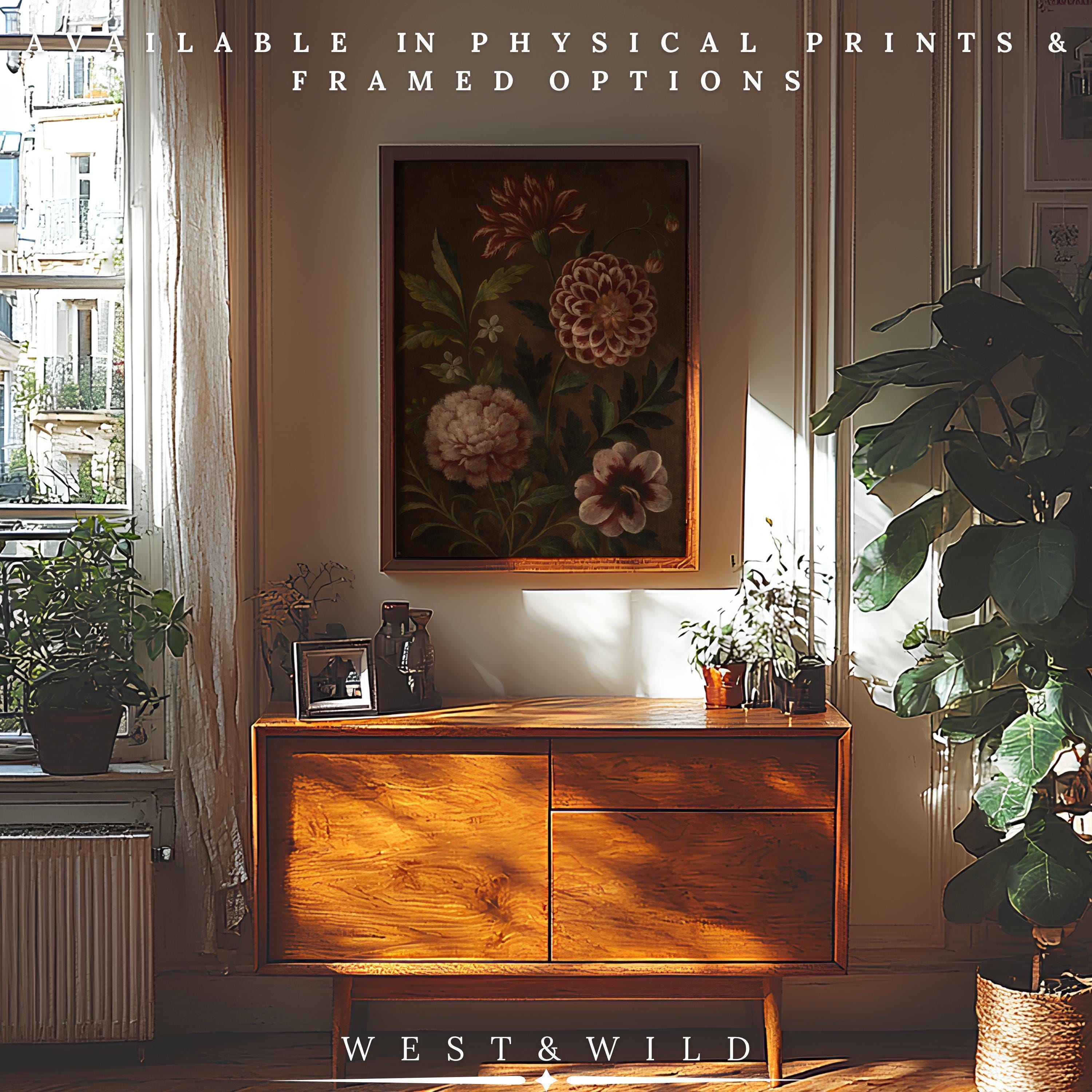 A sunlit room with a wooden sideboard, houseplants, and a Vintage Red Dahlia Print - Burgundy Floral Art on the wall. Available as archival quality physical prints & framed artwork for your living room.