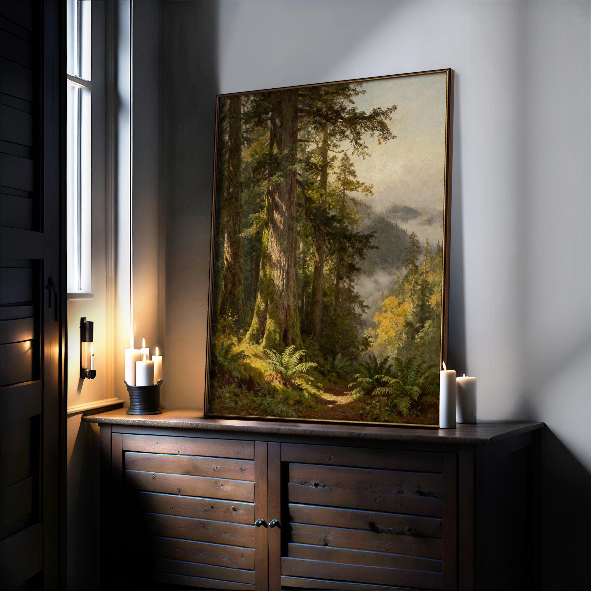 a large painting of a forest scene with tall trees and lush greenery, displayed on a wooden cabinet or shelf. The painting is illuminated by candles, creating a warm and cozy atmosphere in the room.