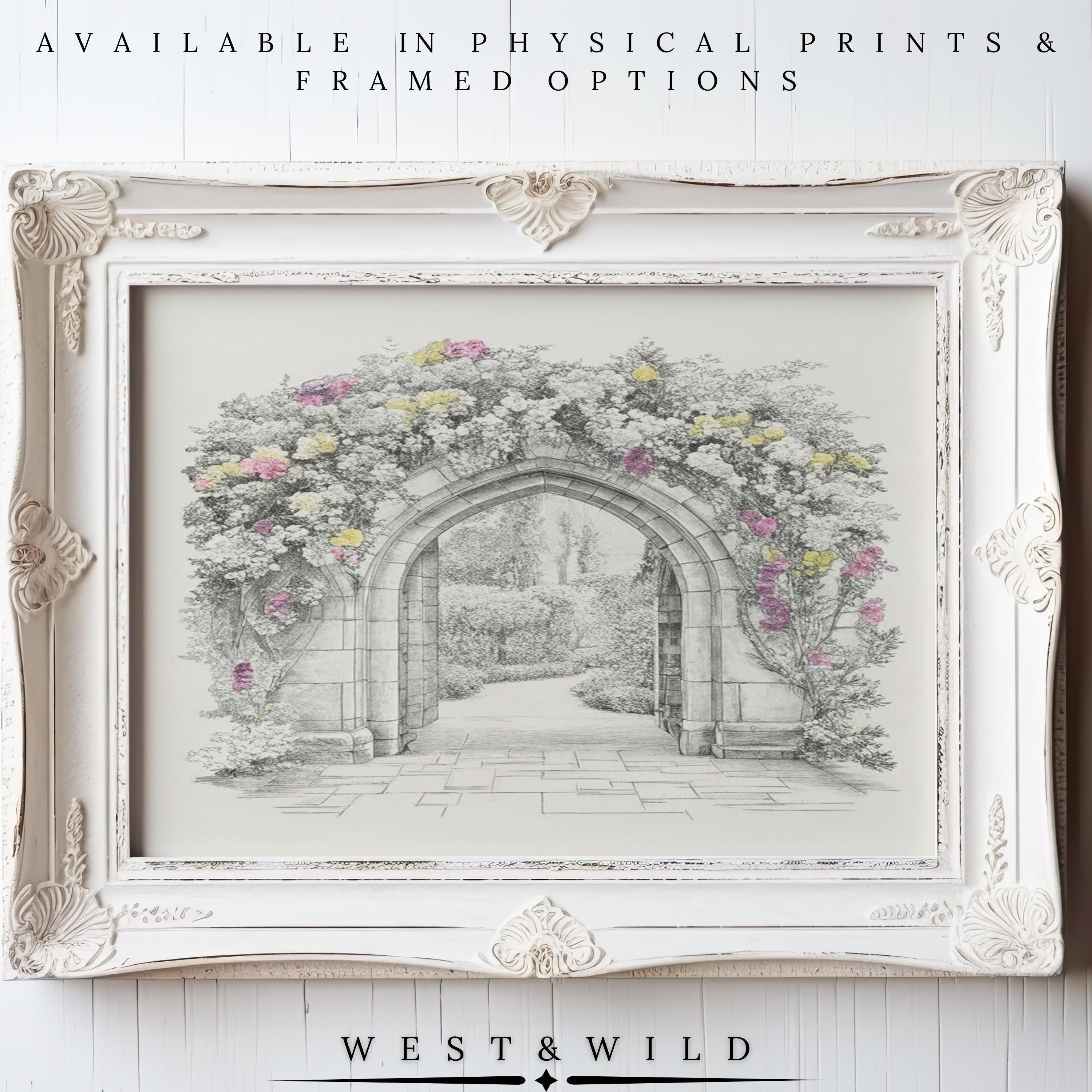 A vintage-style ornate white frame surrounds a black-and-white garden archway with vibrant blooms. The Gothic Stone Archway Print is archival quality, available as framed botanical wall art or vintage art prints from West & Wild Art Archive.