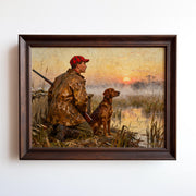 A man in a plaid hat and jacket sits on the ground, holding a rifle, with a dog beside him, in a serene landscape with a sunset in the background.