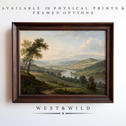 A Landscape Oil Painting Print – American Valley Wall Art with wood frame options is shown on a white wall, featuring rolling green hills and a river. Available as vintage art prints and framed art from West & Wild Art Archive. Archival quality guaranteed.