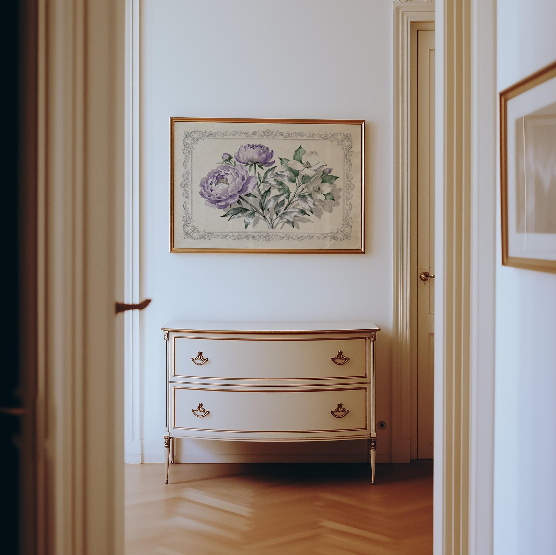 a hallway with a white dresser and a framed floral artwork hanging on the wall above it.