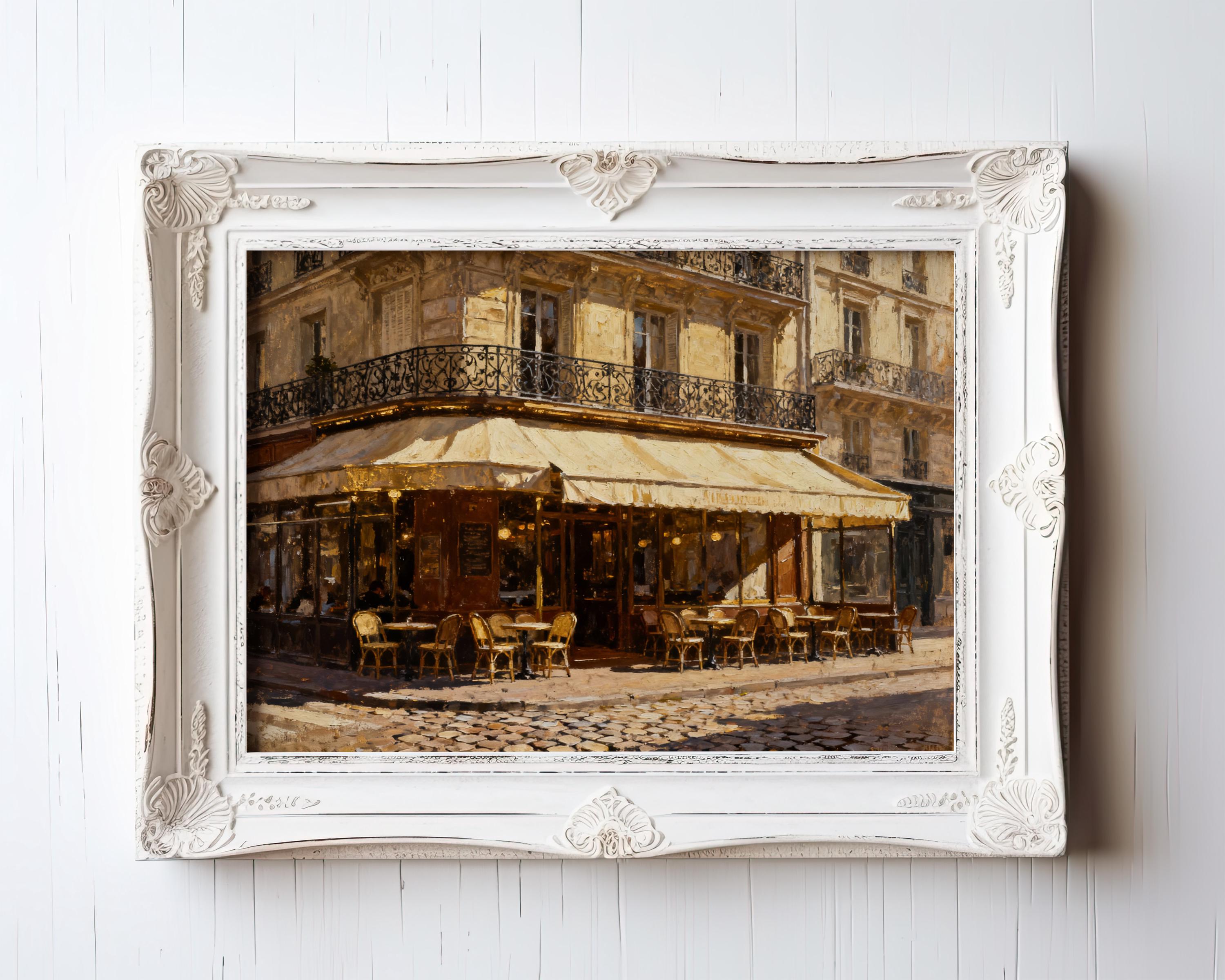 The Vintage Paris Wall Art – Paris Cafe Art Framed or Unframed European Print showcases a charming cafe with outdoor tables on a cobblestone street, set against an old Parisian building with wrought-iron balconies.