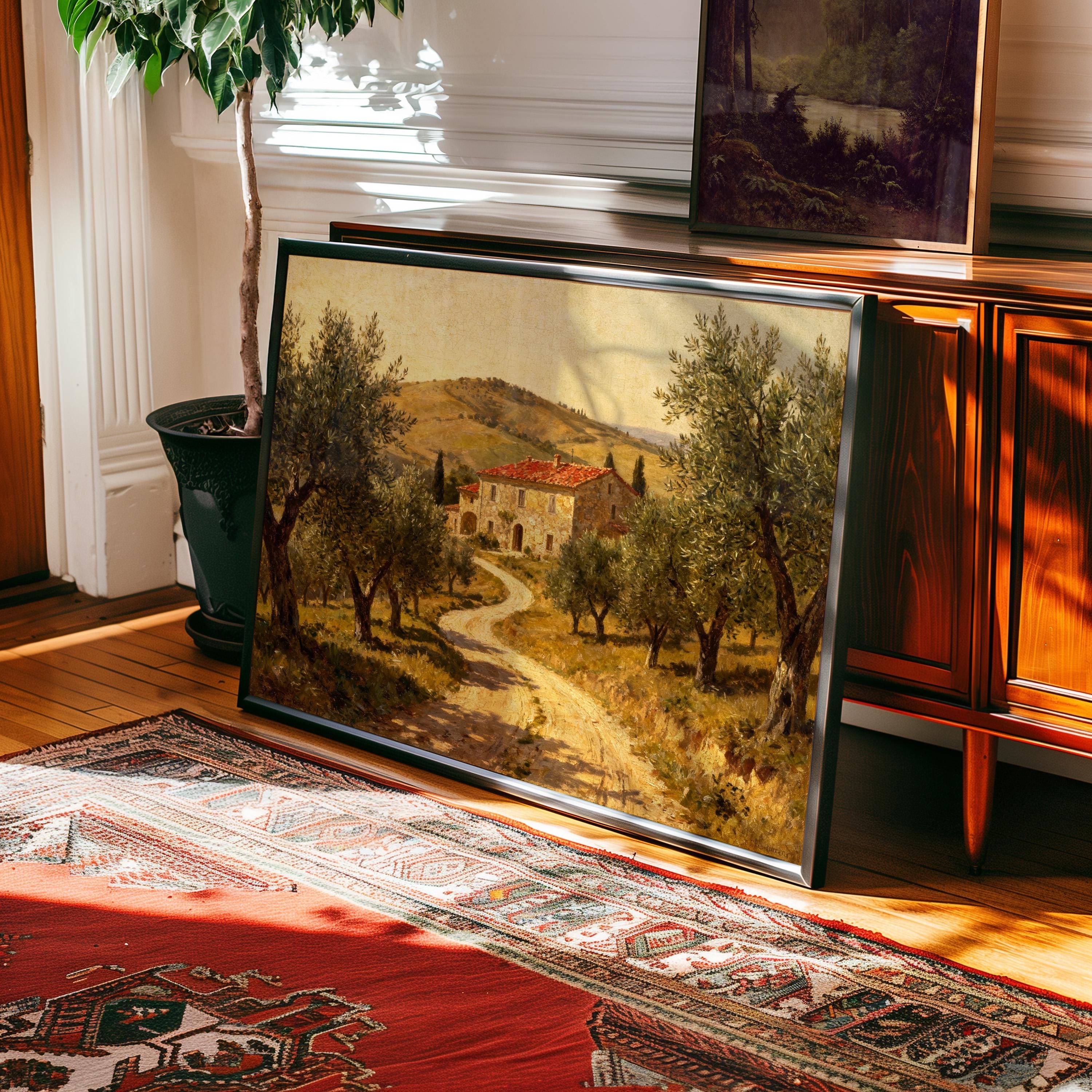The Tuscan Farmhouse Print – Vintage Olive Tree Art with framed wall options from West & Wild Art Archive leans on a console in a sunlit room, paired with a patterned rug and potted plant for a serene, timeless setting.