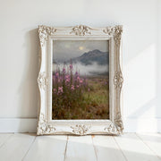 a white ornate frame with a painting of a field of purple flowers and a mountain landscape in the background.
