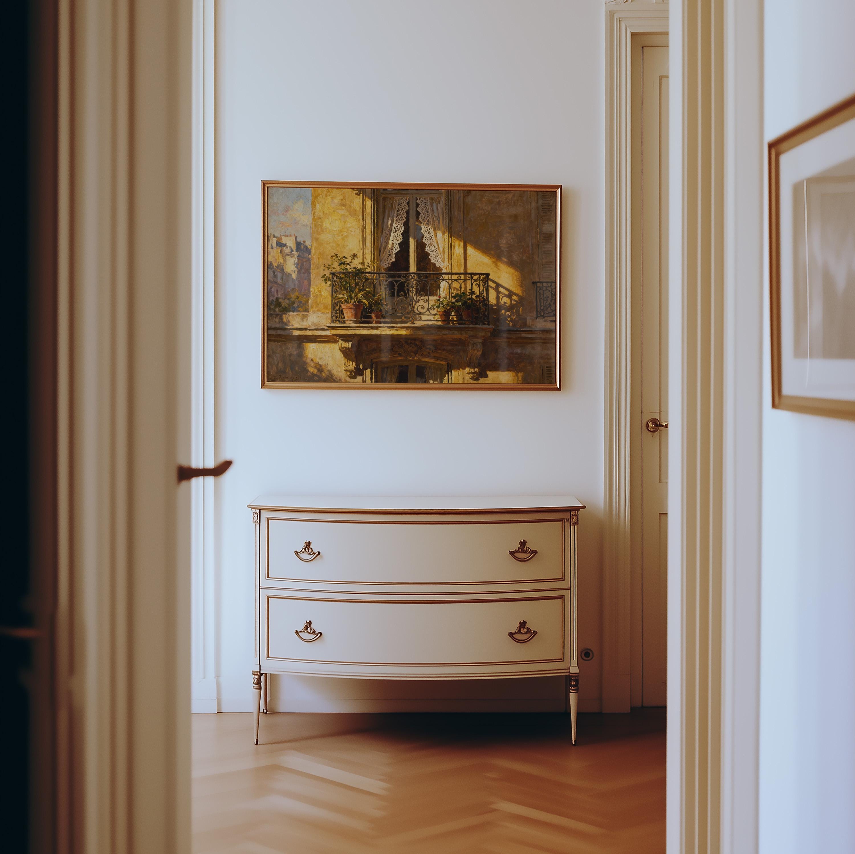 A hallway with light wood floors leads to a cream dresser with gold handles, topped by the Vintage Paris Balcony Print—French wall decor featuring lace curtains. White walls frame another partially visible artwork on the right.