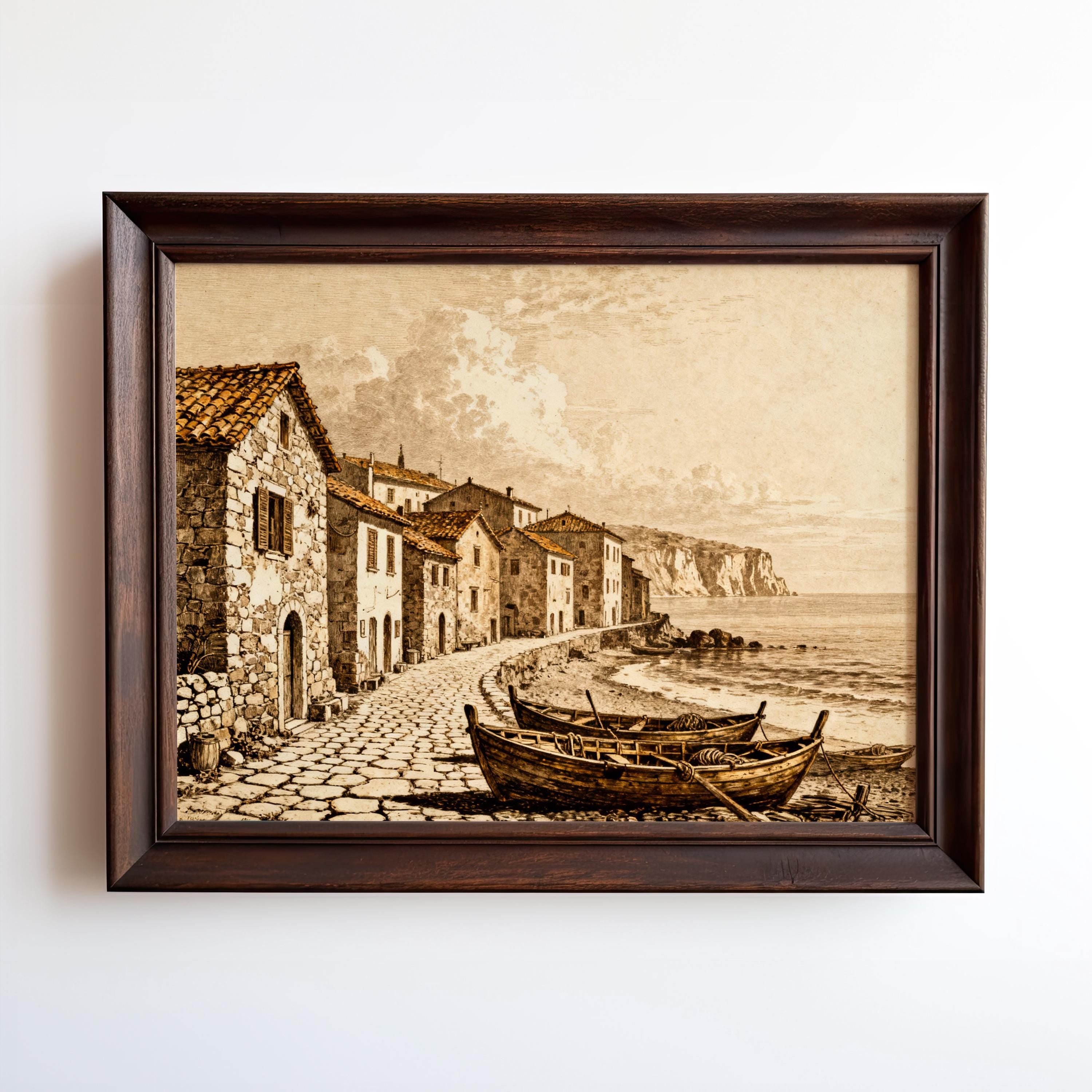 Vintage Coastal Wall Decor – Seaside Village Art Print features a nautical harbor illustration with stone houses, cobblestone path, and fishing boats by a calm sea. Framed art print, archival quality vintage decor from West & Wild Art Archive.
