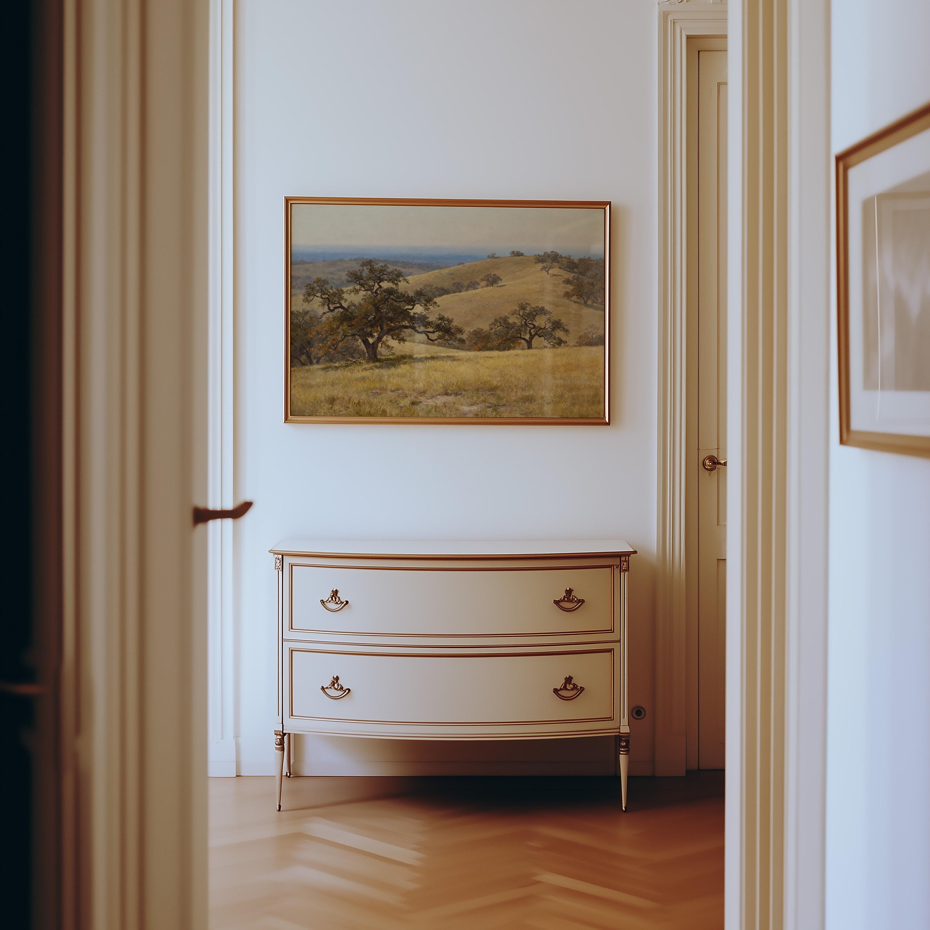 a hallway with a white dresser and a framed landscape painting hanging on the wall above it.