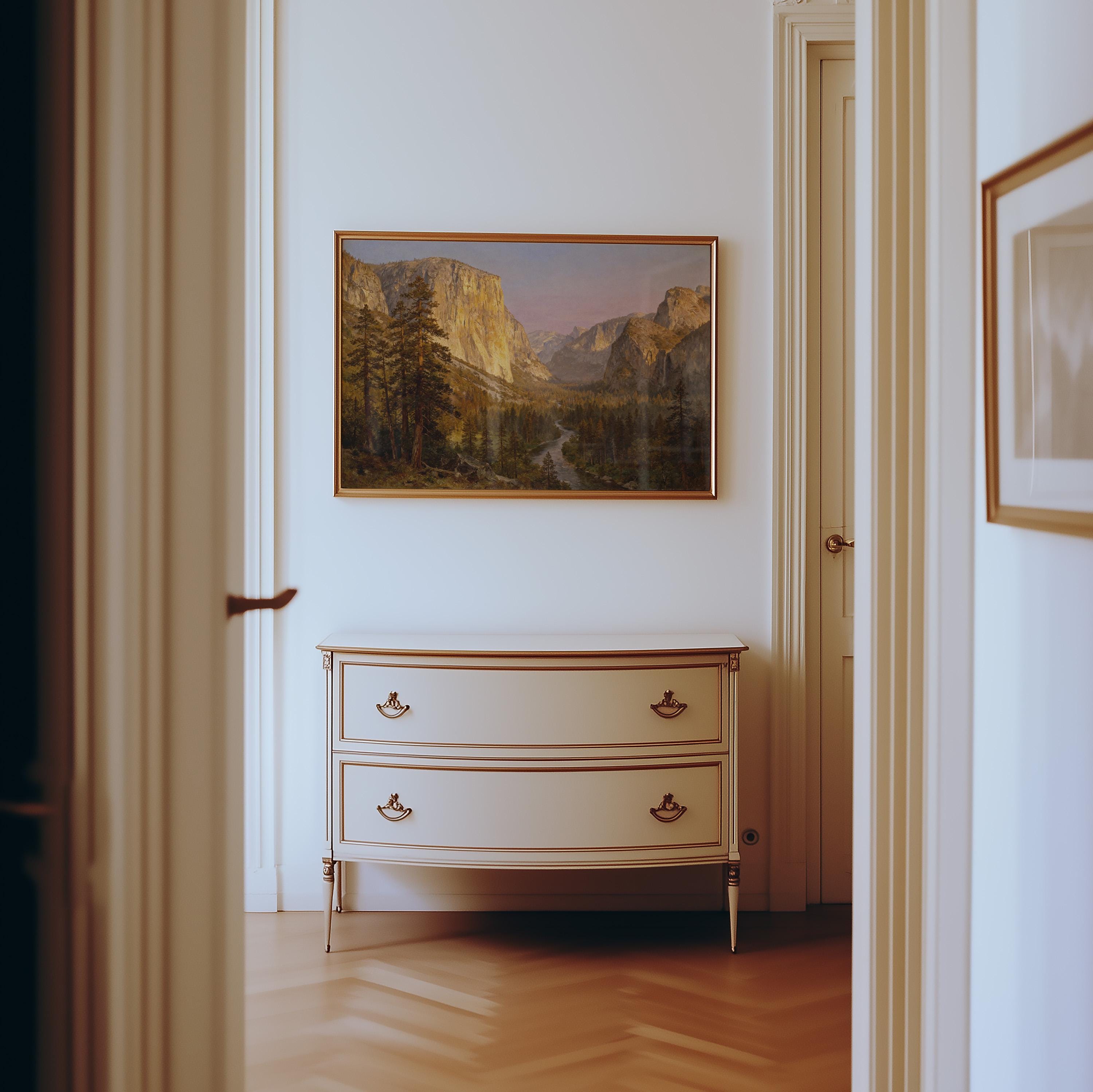 a hallway with a painting of a mountain landscape hanging on the wall above a white dresser with two drawers.