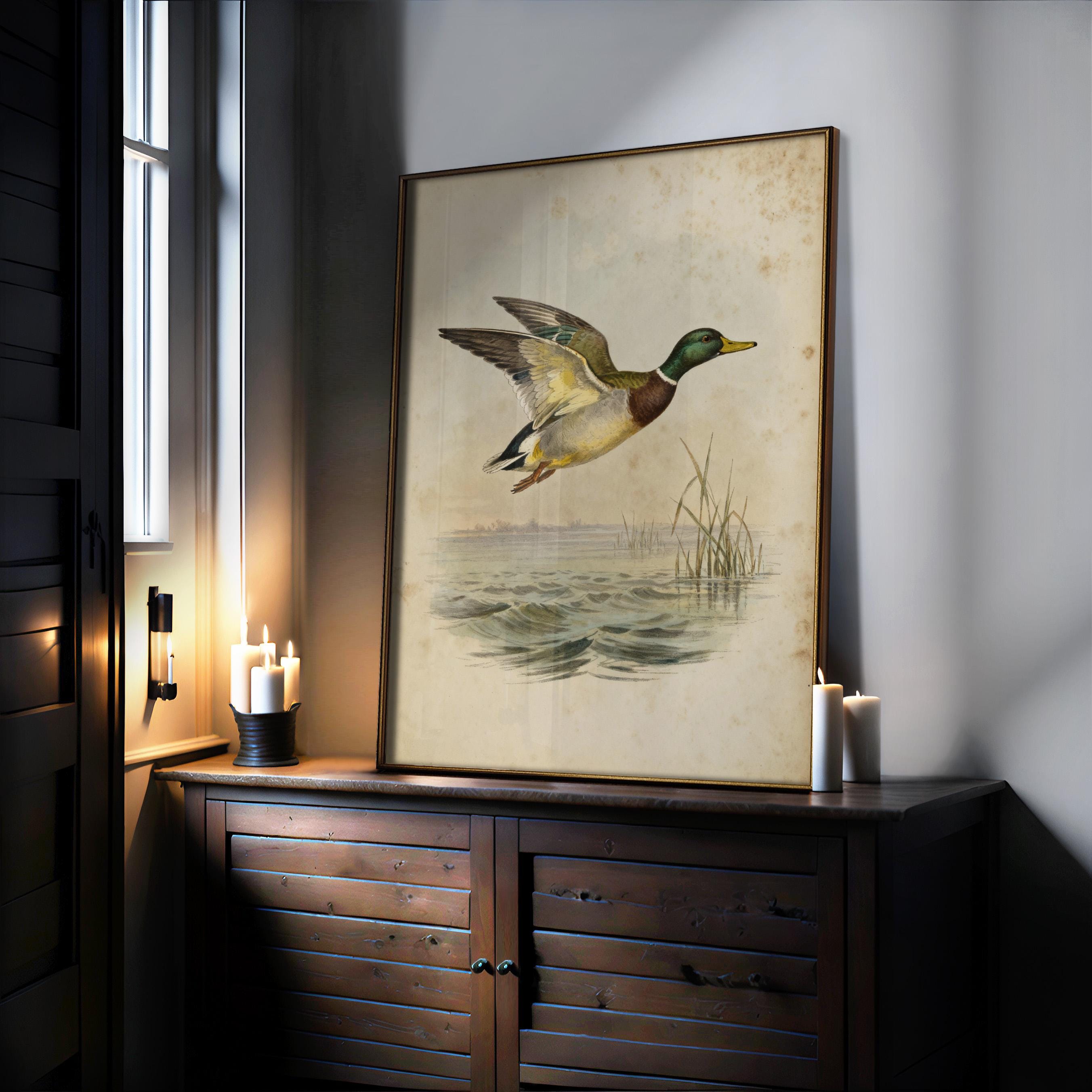 a large framed painting of a duck in mid-flight, displayed on a wooden cabinet or shelf.