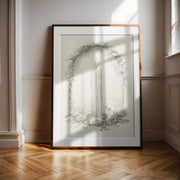 A large framed artwork depicting a candle surrounded by flowers and leaves is displayed on a wooden floor in a room with white walls.