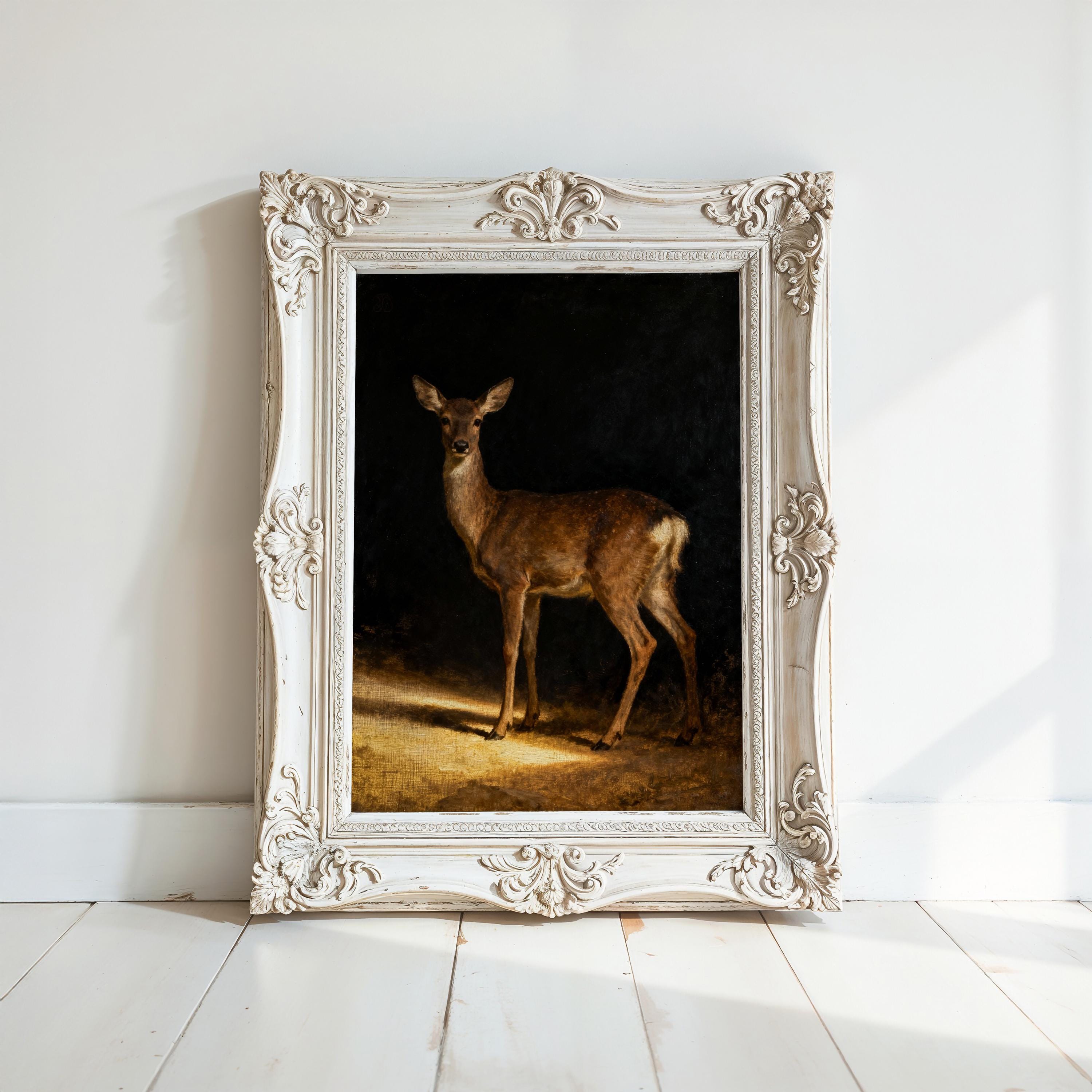 a deer standing in a dark background, framed in an ornate white frame.