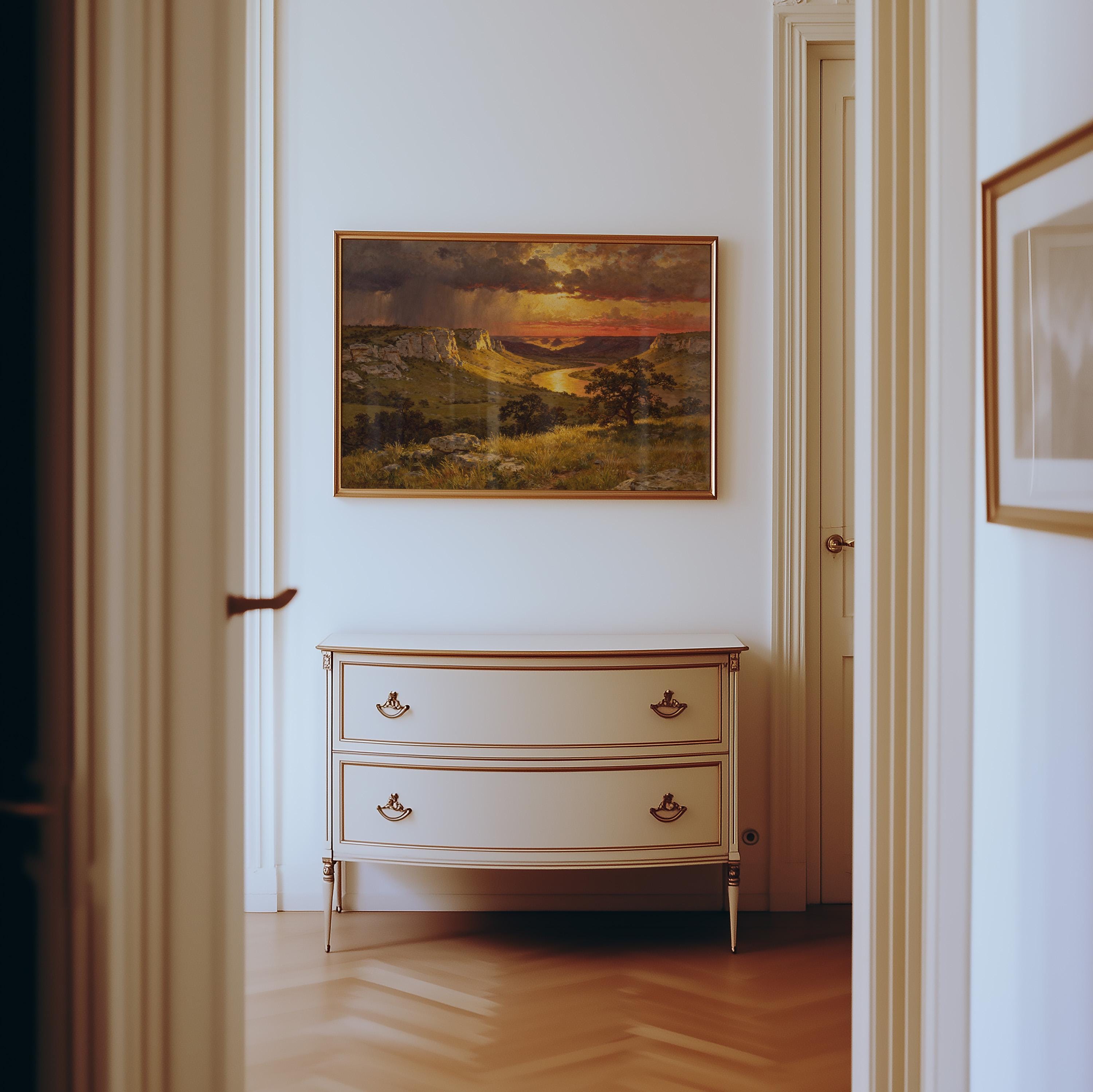 a hallway with a white dresser and a framed landscape painting hanging on the wall above it.