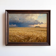 The image is a painting of a vast golden wheat field under a dramatic cloudy sky, with a small building visible in the distance.