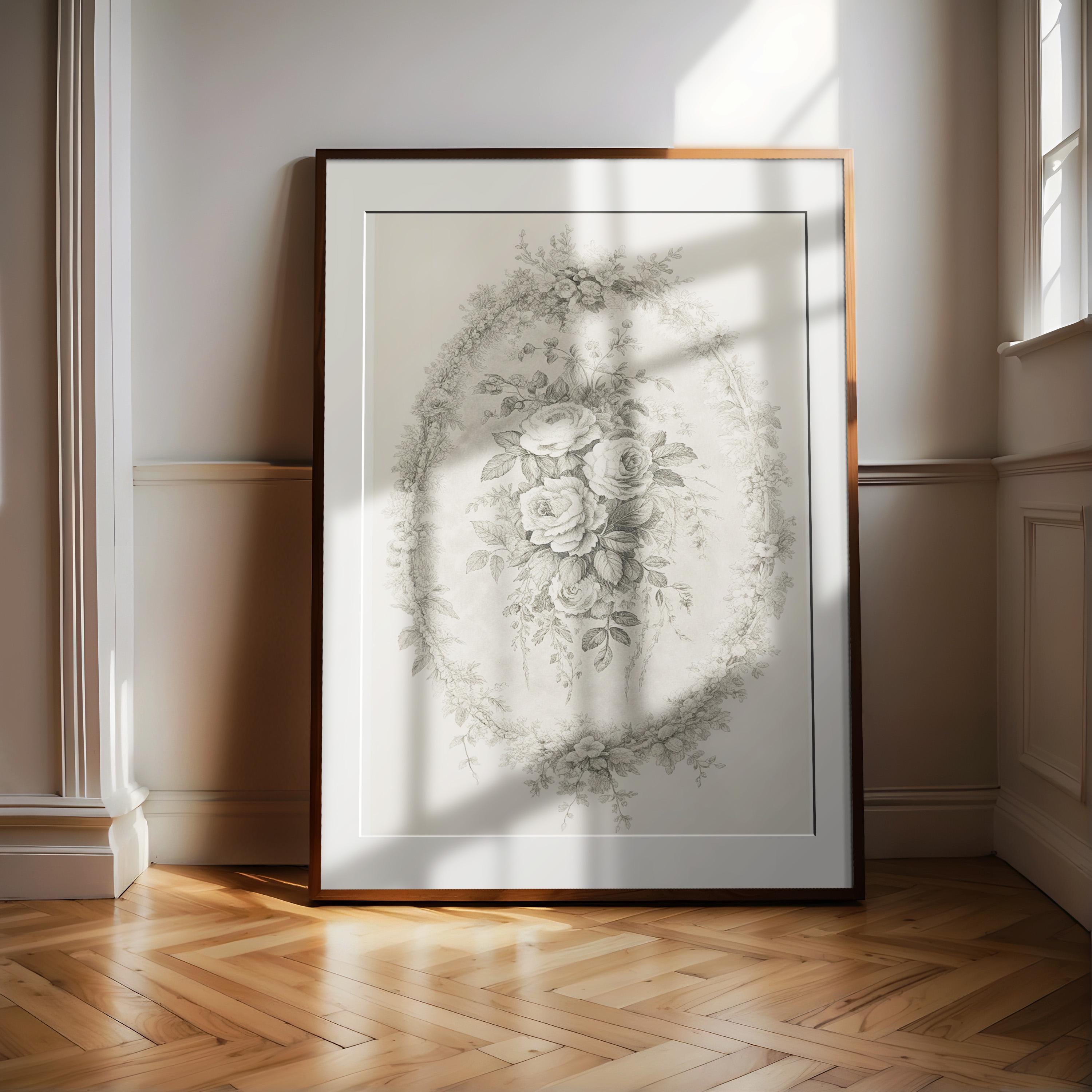 a large, ornate frame with a floral design, placed on a wooden floor in a room with white walls.