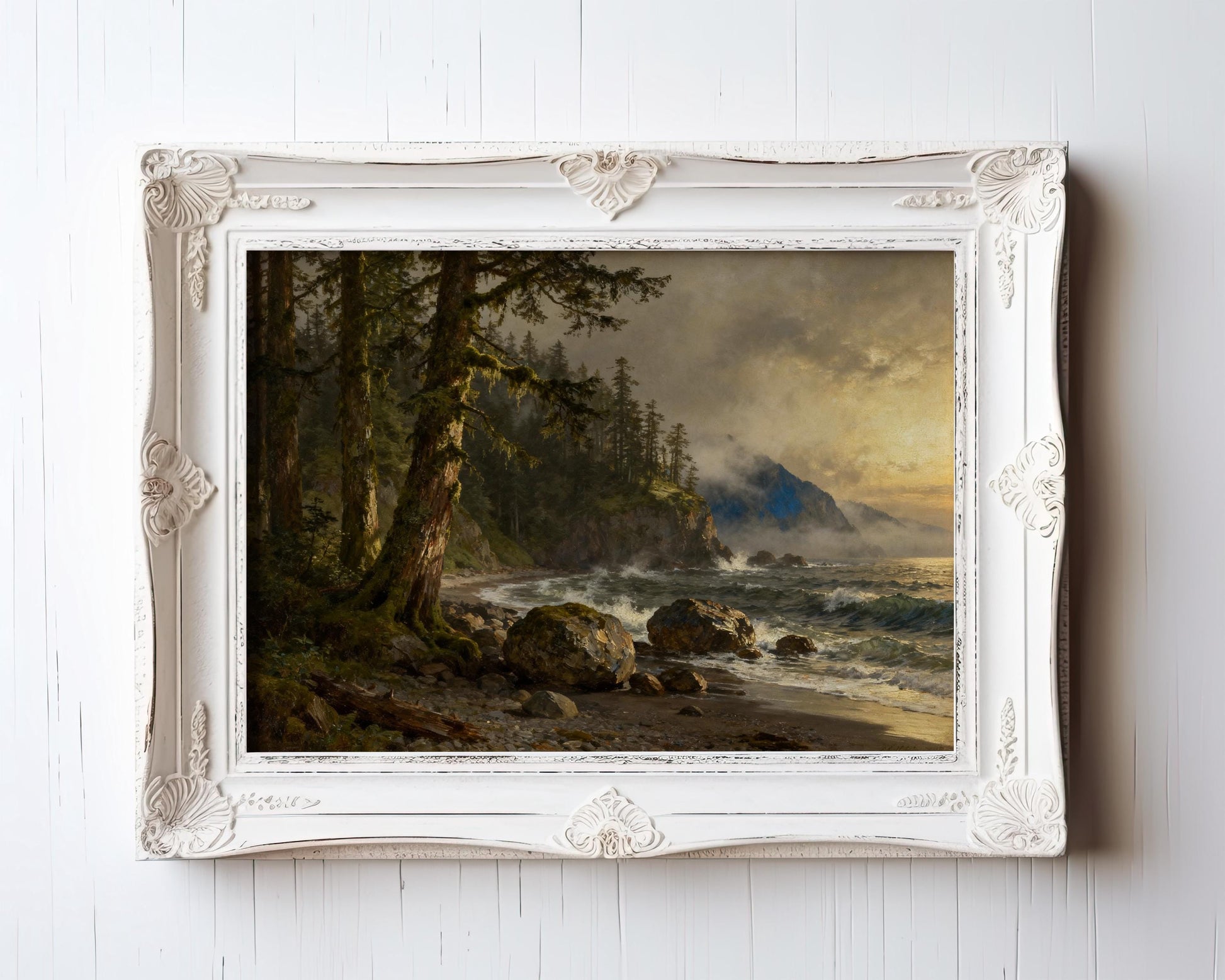 The image is a framed painting depicting a serene coastal landscape with a rocky shore, lush trees, and a body of water with waves crashing against the shore.