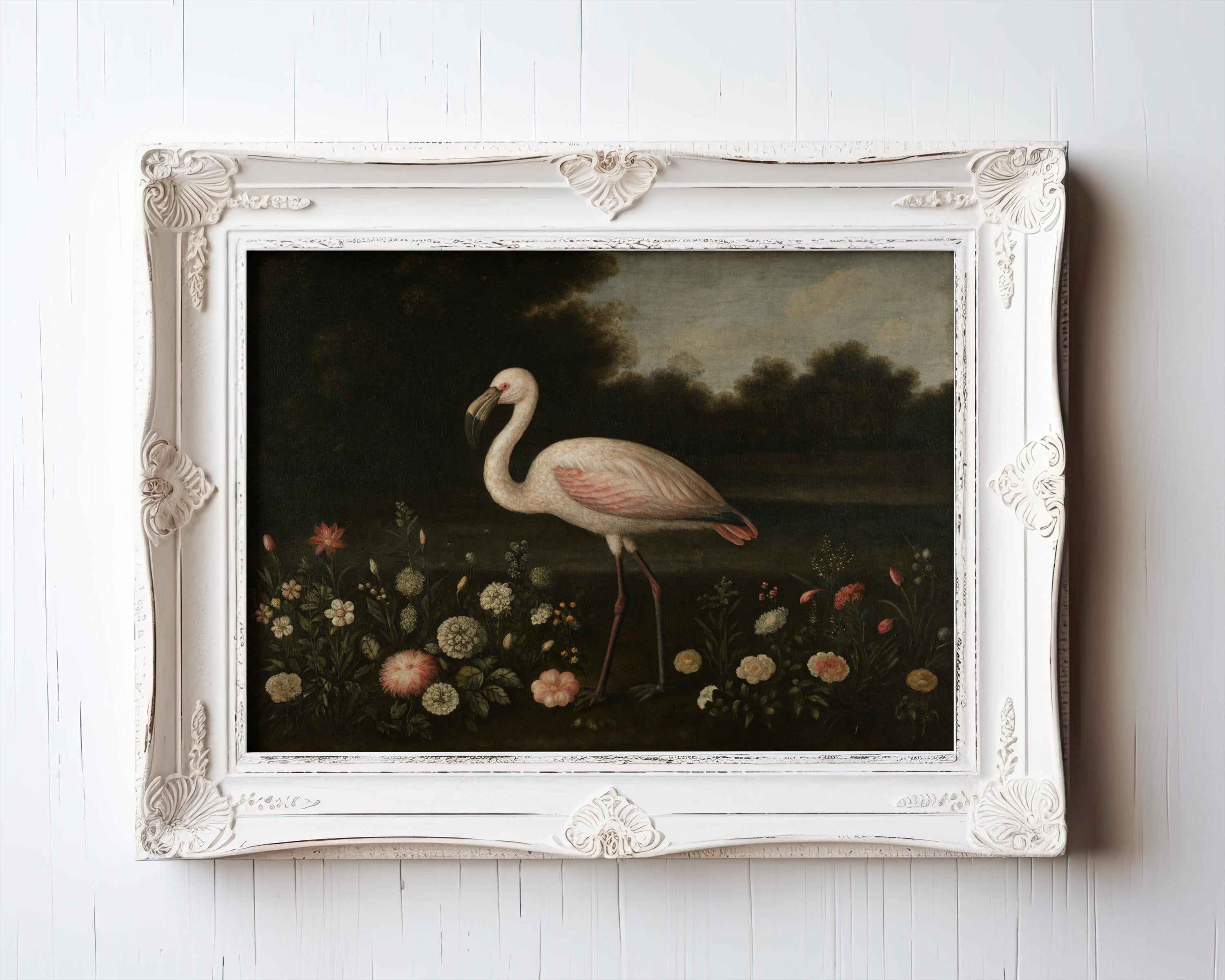 A framed "Vintage Flamingo Art | Elegant Bird Print" with floral accents from the West & Wild Art Archive hangs on a white wooden wall, showcasing cottagecore décor with a pink flamingo among flowers and trees under a dark sky.