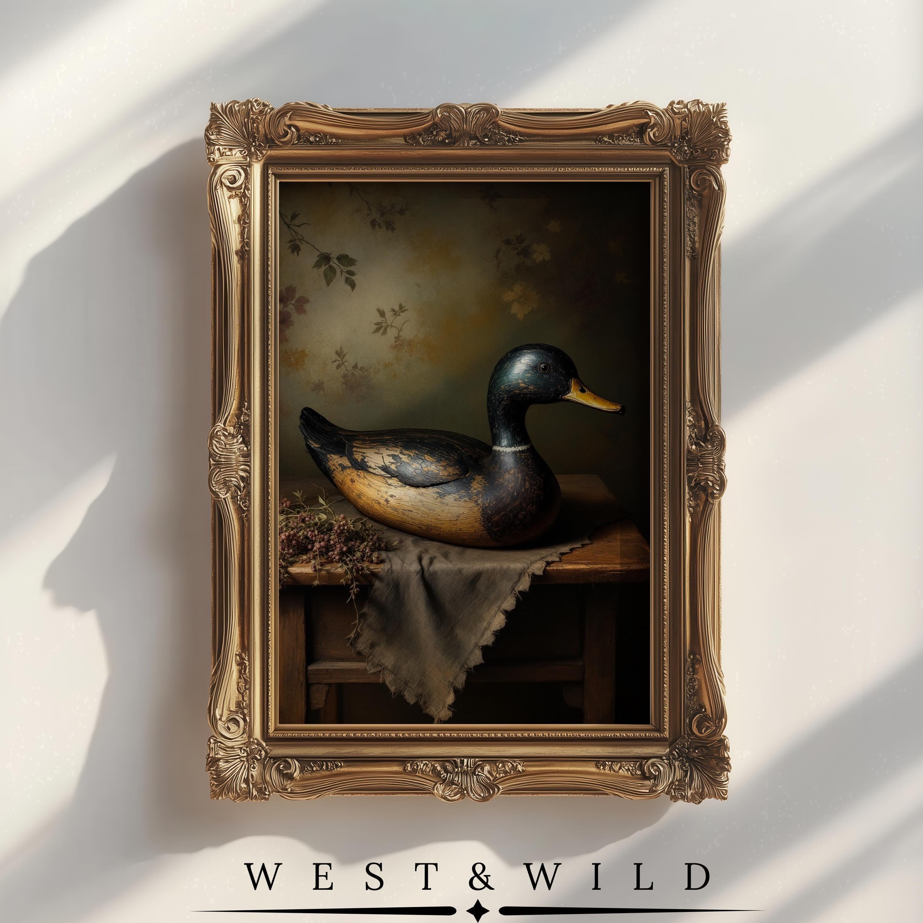 The Duck Wall Art features a vintage Mallard oil painting with a wooden decoy, set on a table with a floral background and branded "WEST & WILD" from the West & Wild Art Archive. Perfect vintage art print for your wall décor.