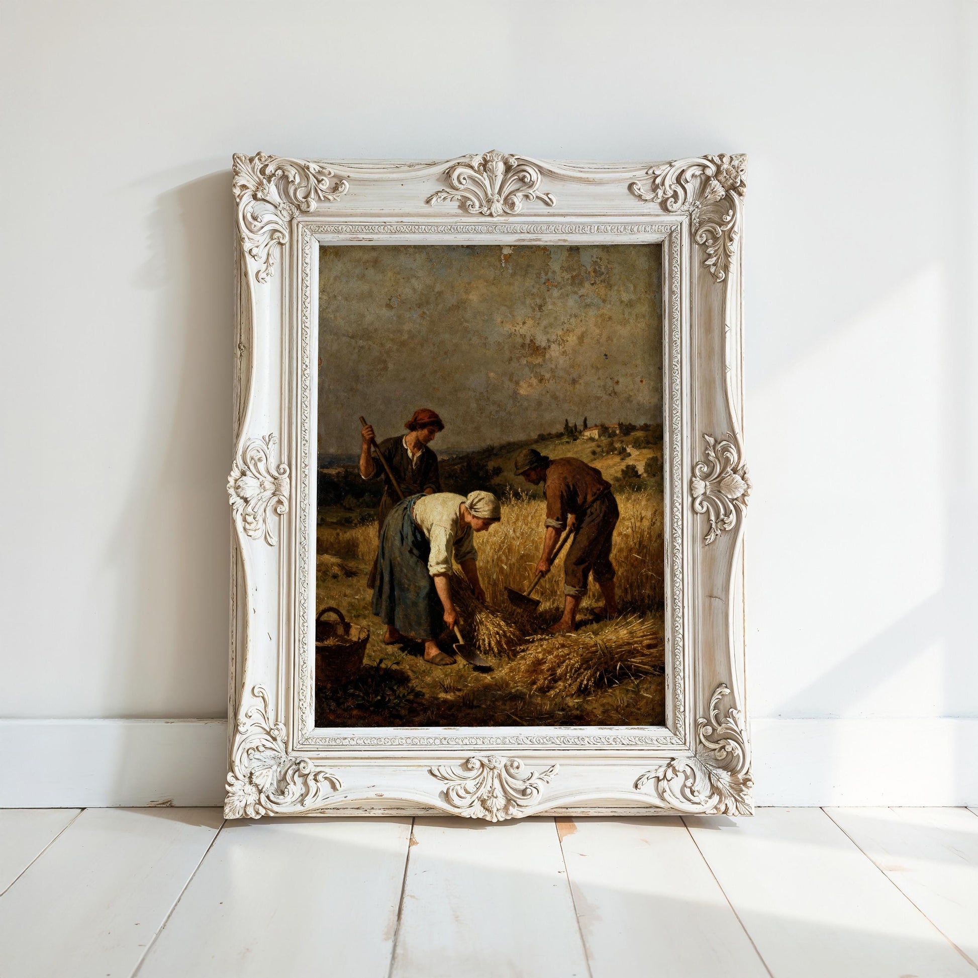 The image is a painting of three people working in a field, with a white ornate frame surrounding the artwork.