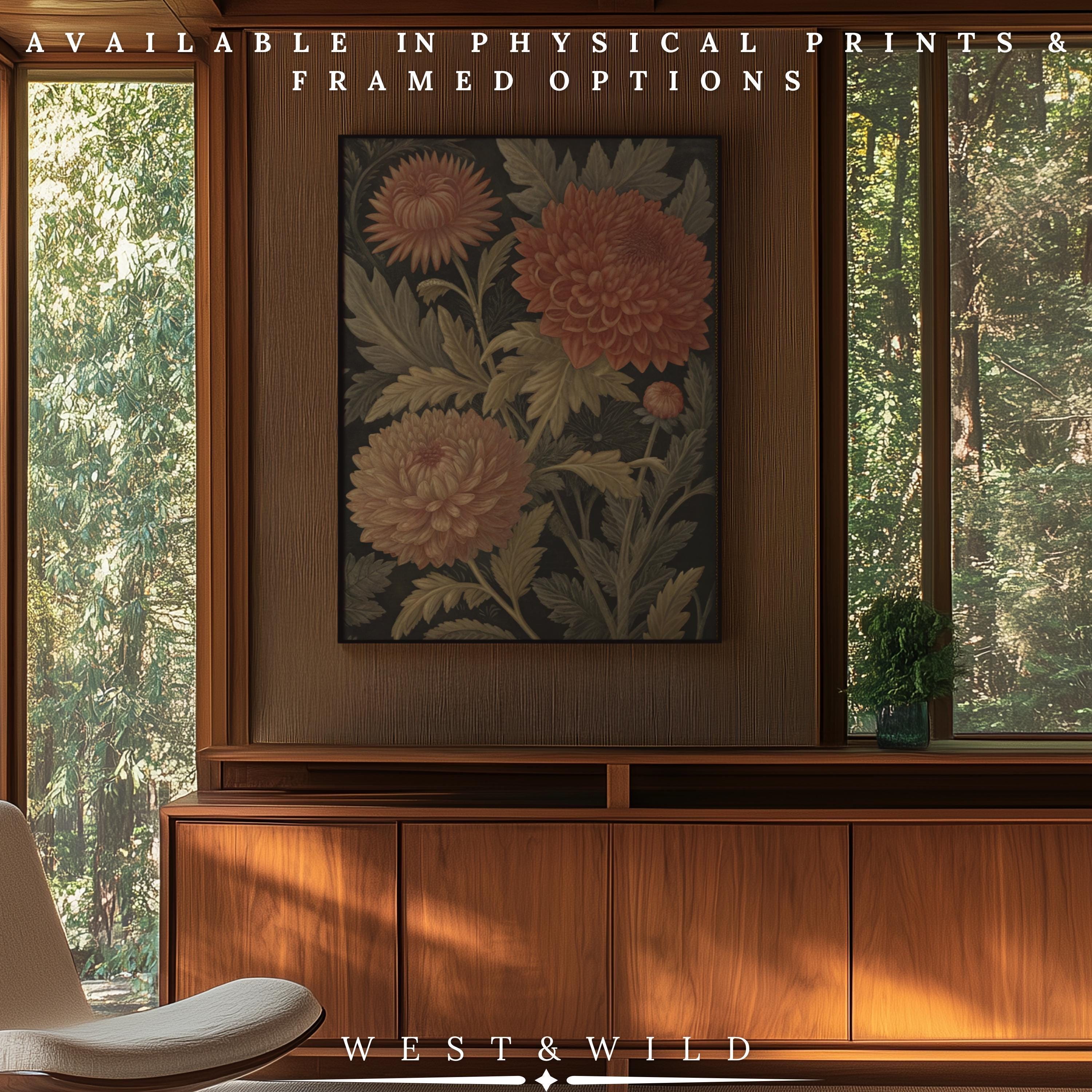 A mid-century modern room with wood-paneled walls, large windows with a forest view, and the Vintage Chrysanthemum Art – Coral Pink Dahlia Framed Floral Print above a wooden cabinet. Available as archival quality prints & framed art from West & Wild Art Archive.