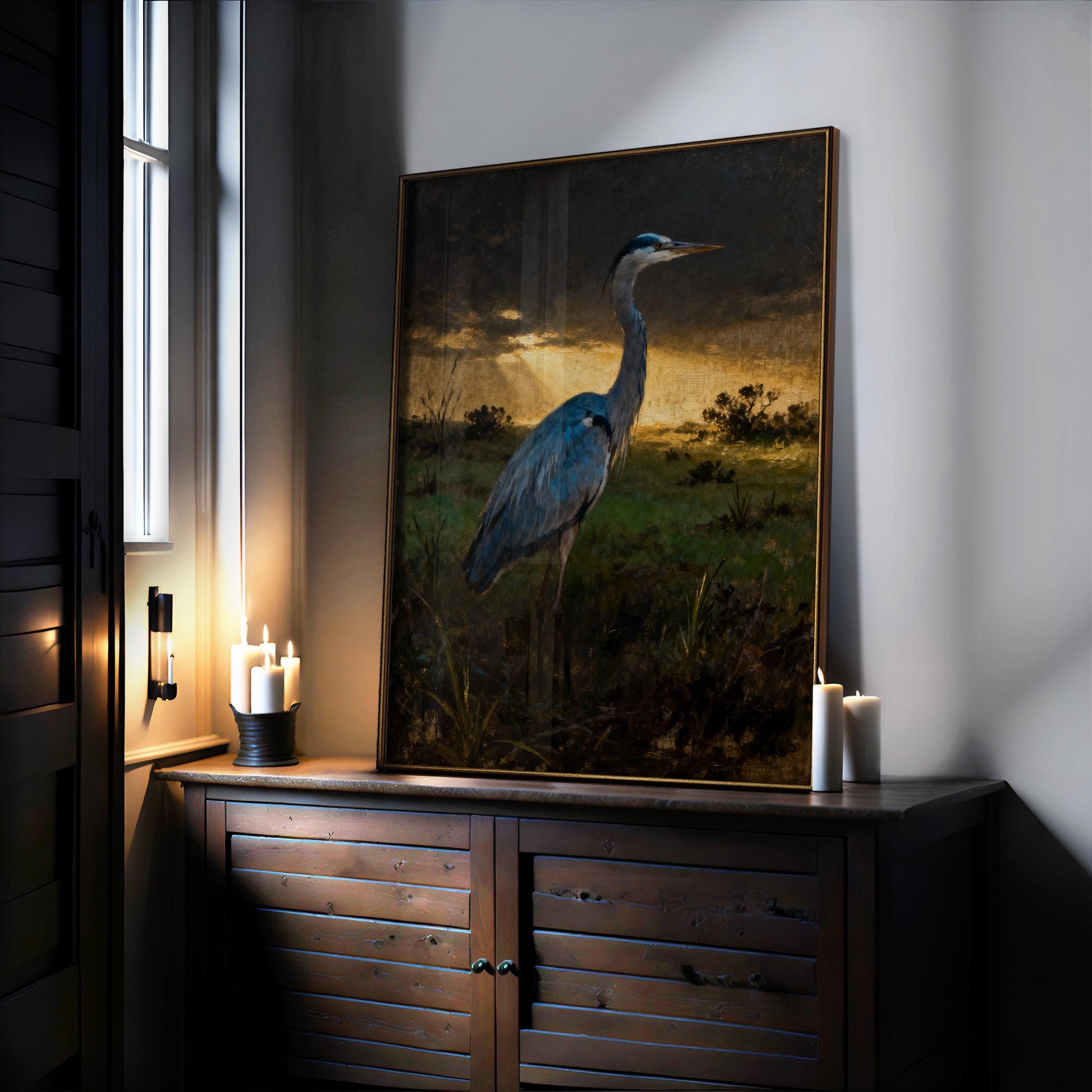 a large painting of a blue heron standing in a grassy field, with a warm, golden sunset in the background.