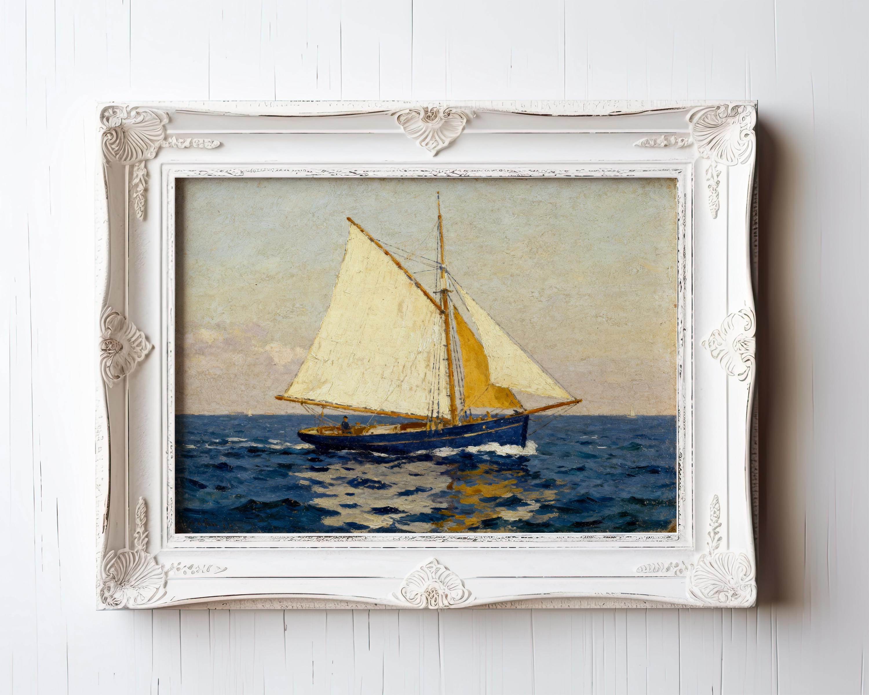The Blue Sailboat Art Print – Vintage Nautical Wall Decor features a sailboat with cream sails on blue water under a pastel sky. Archival quality from West & Wild Art Archive, perfect for coastal homes. Framed art for your white wooden wall.