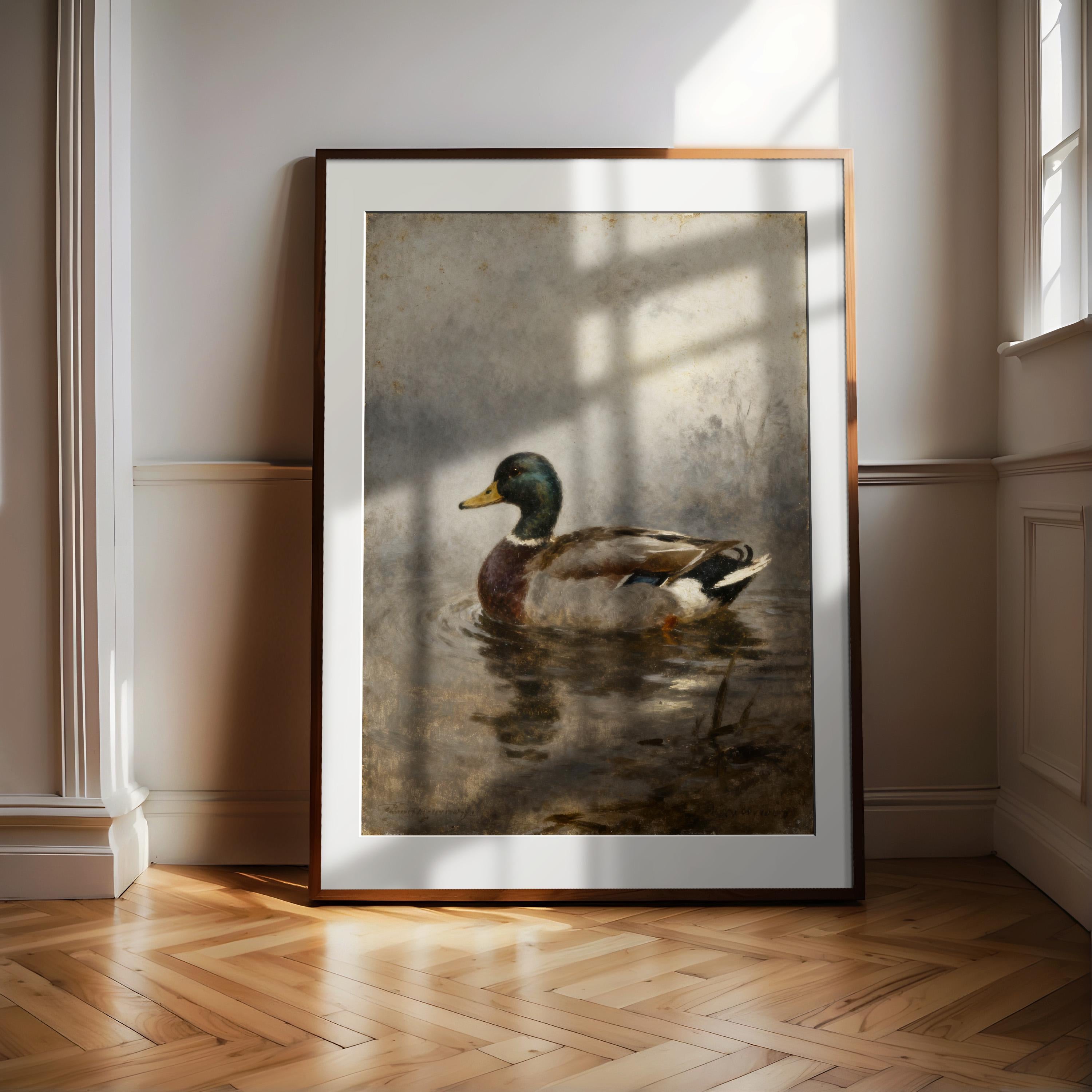 A framed painting of a duck swimming in a body of water is displayed on a wooden floor in a room with white walls.