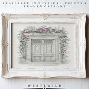 A vintage-style white frame displays the “European Doorway Wall Art – Vintage Architectural Print With Framed Botanical Sketch,” featuring double doors with pink climbing roses. Available as archival quality prints & framed art by West & Wild.