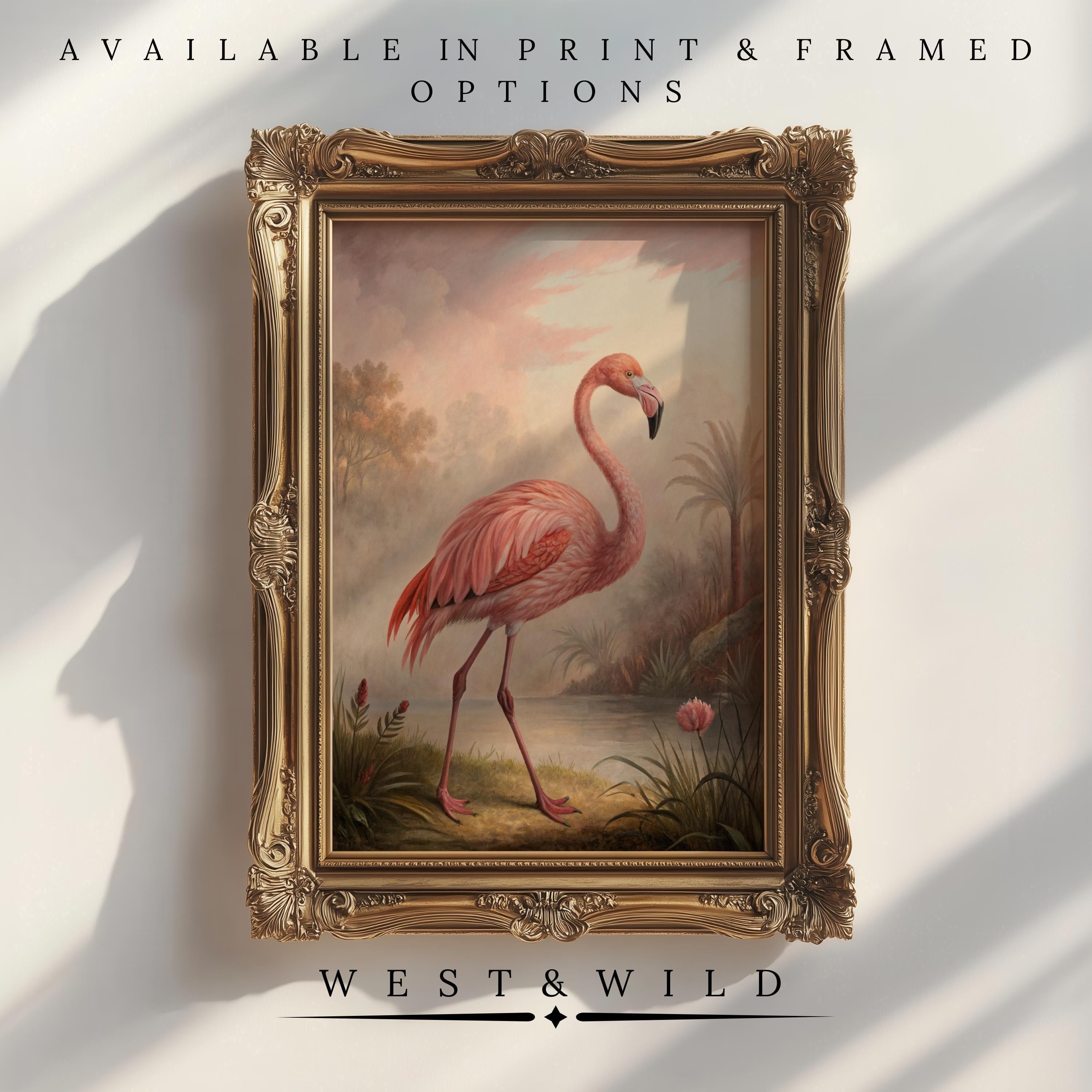 A framed Pink Flamingo Wall Art - Vintage Bird Print with a flamingo by a pond and plants, displayed on a wall. Above and below, text reads: Available in print & framed options and West & Wild Art Archive.