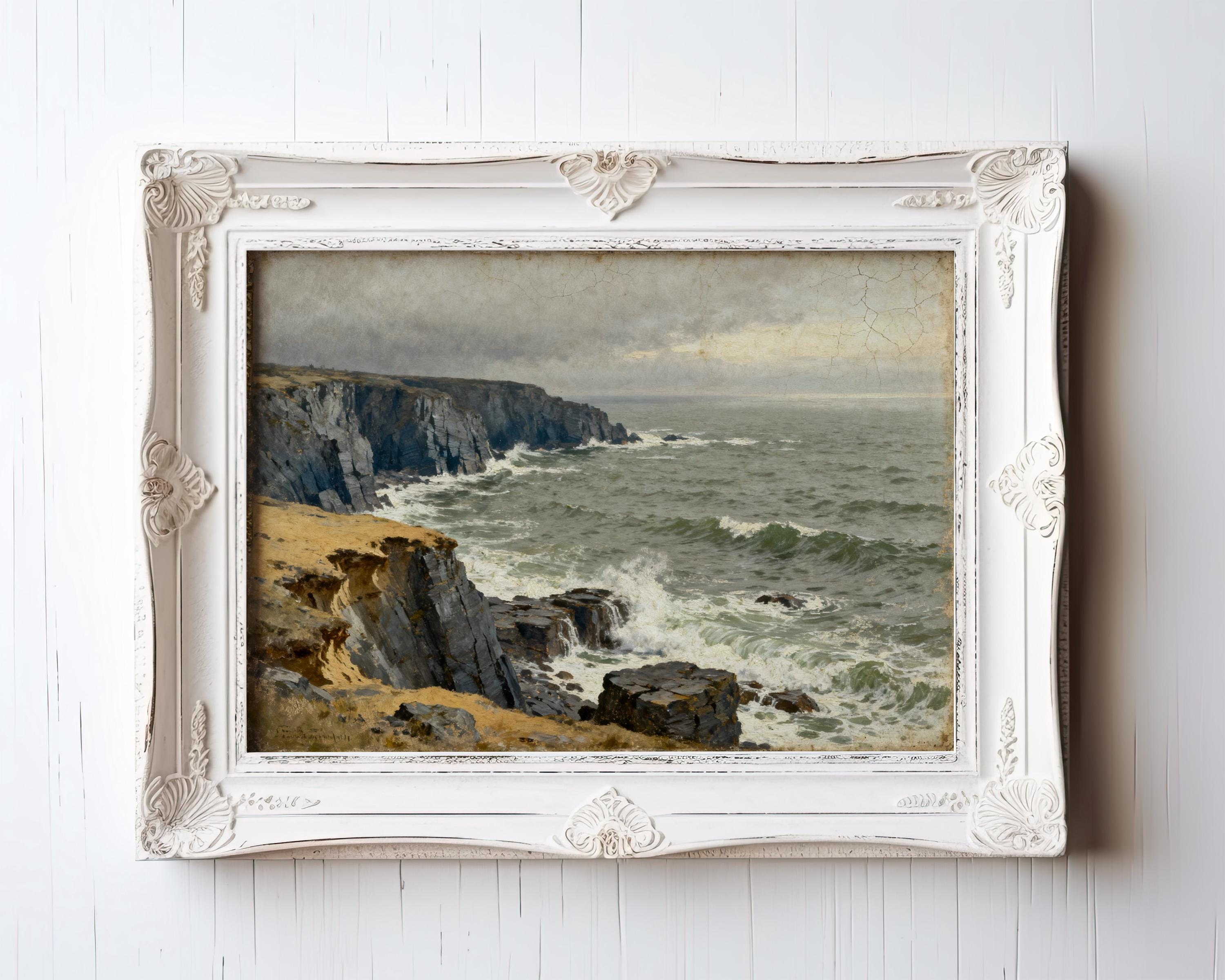 The image is a painting of a rocky coastline with crashing waves, displayed in a white ornate frame.