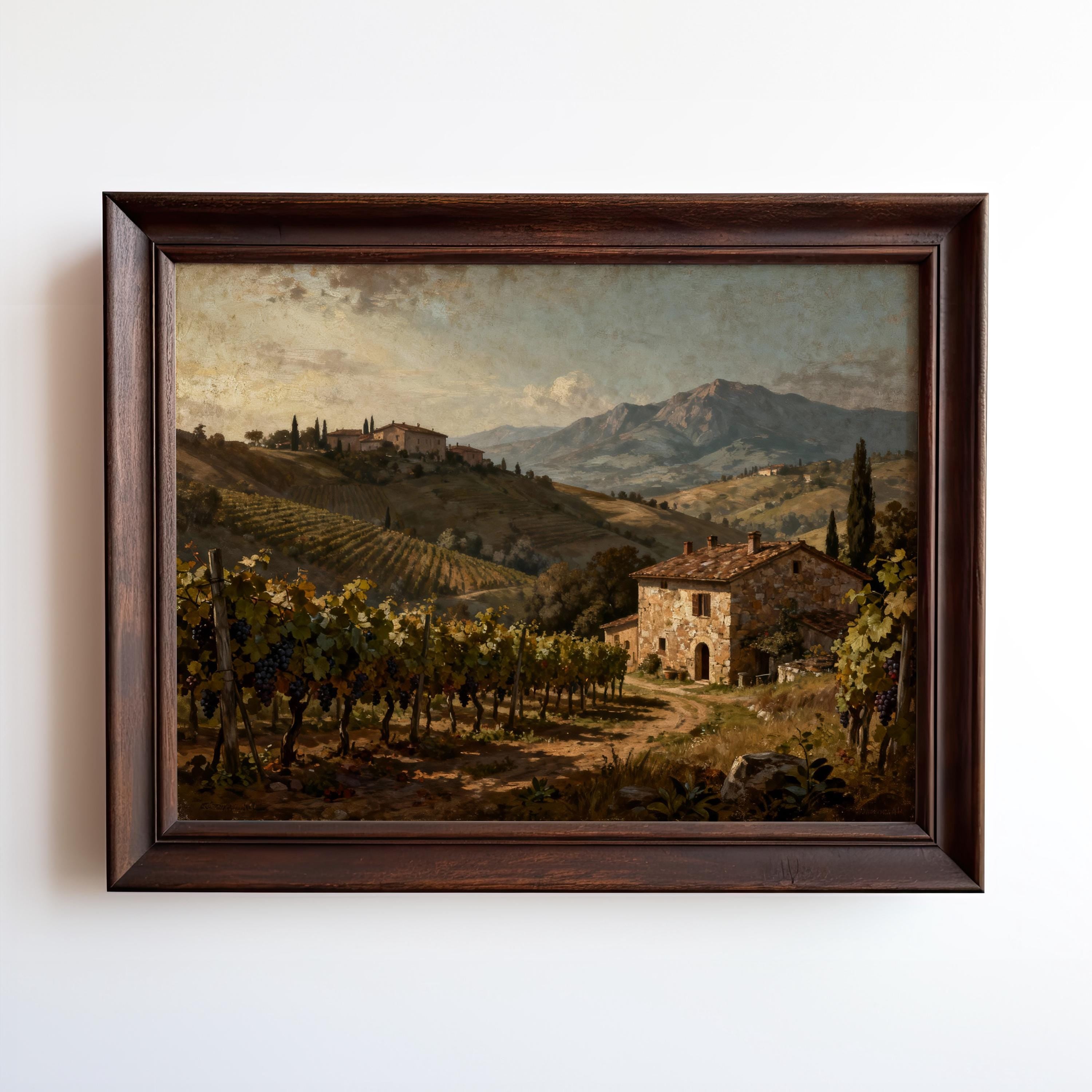 The Tuscan Vineyard Art Print – Framed Farmhouse Decor features a rustic stone house among vineyard rows and rolling hills, with a distant farmhouse under a partly cloudy sky—ideal for Mediterranean-inspired spaces.