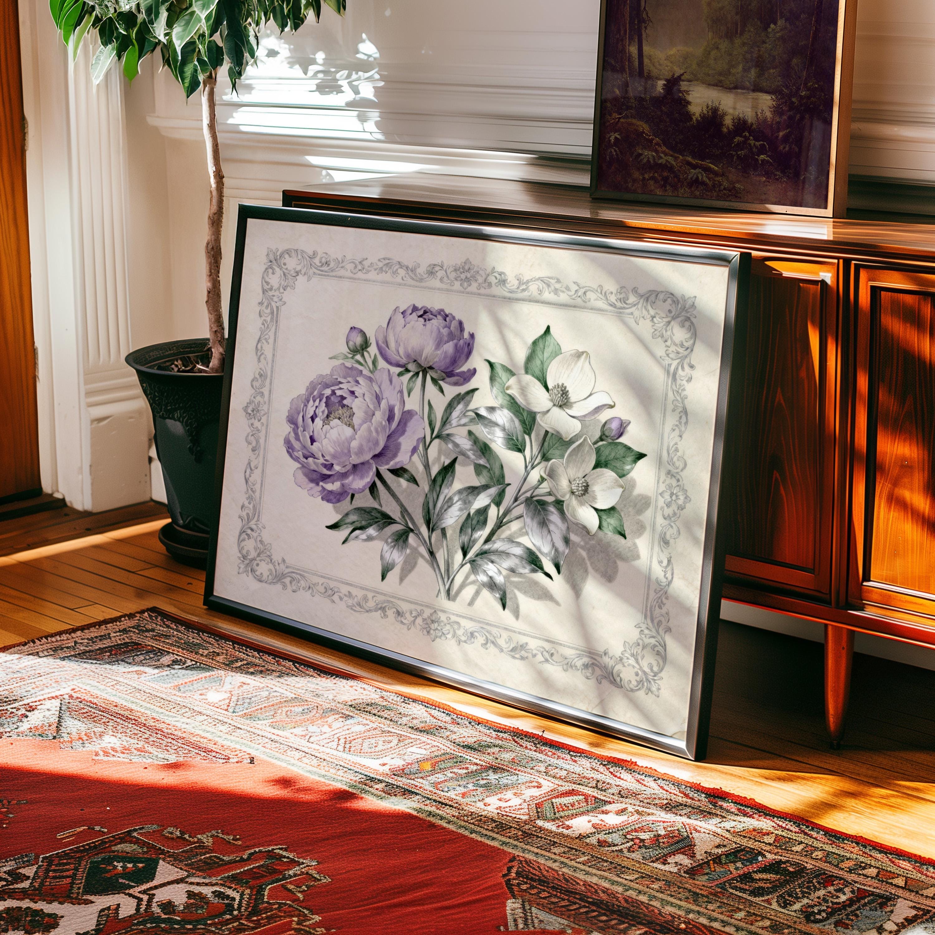 a large framed painting of purple and white flowers on a wooden surface, with a rug and a plant in the background.