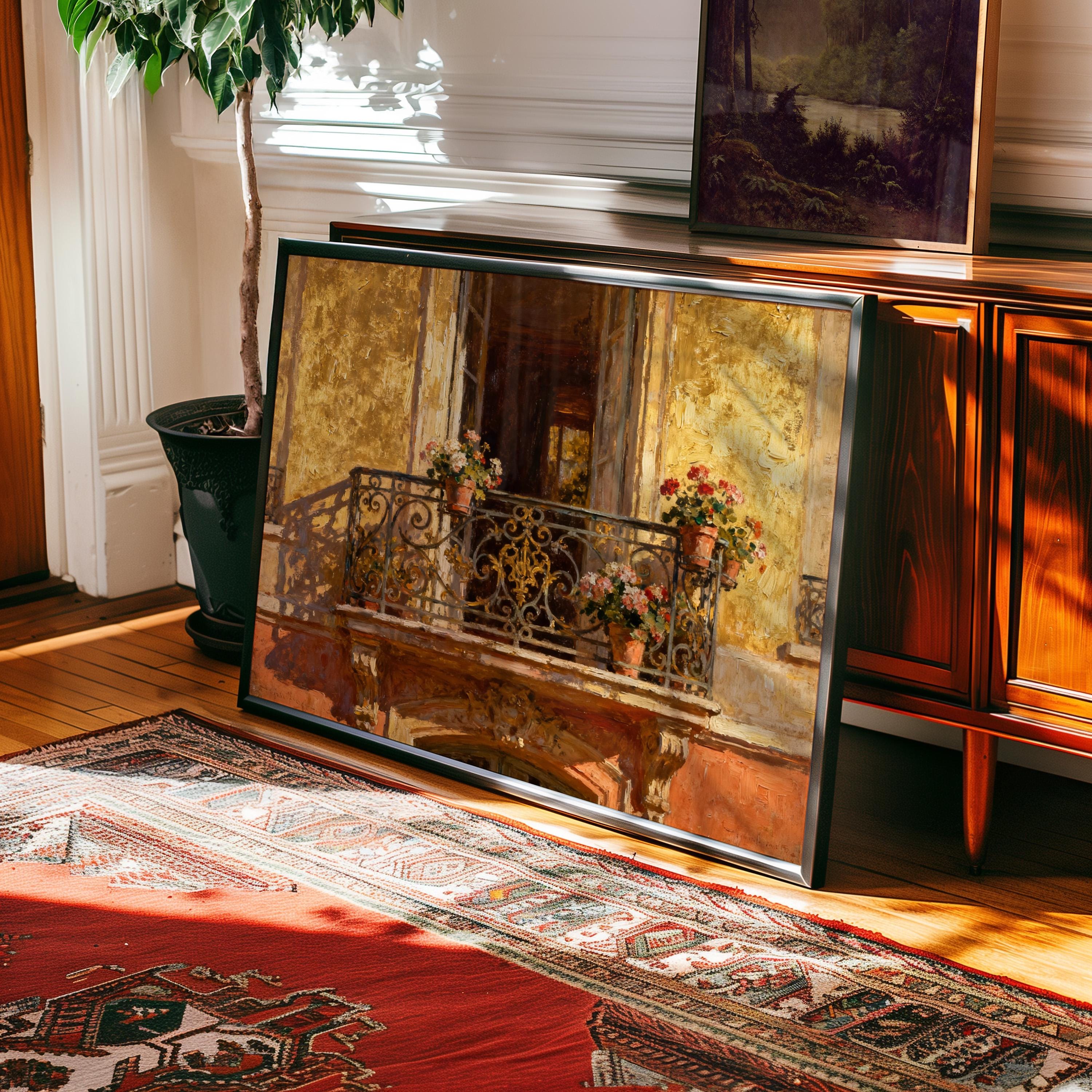 The Vintage Paris Balcony Print – Golden Facade Art with Flower Pots, framed or unframed, features ornate ironwork and blooms, shown resting by a wooden cabinet with plants—part of the West & Wild Art Archive.