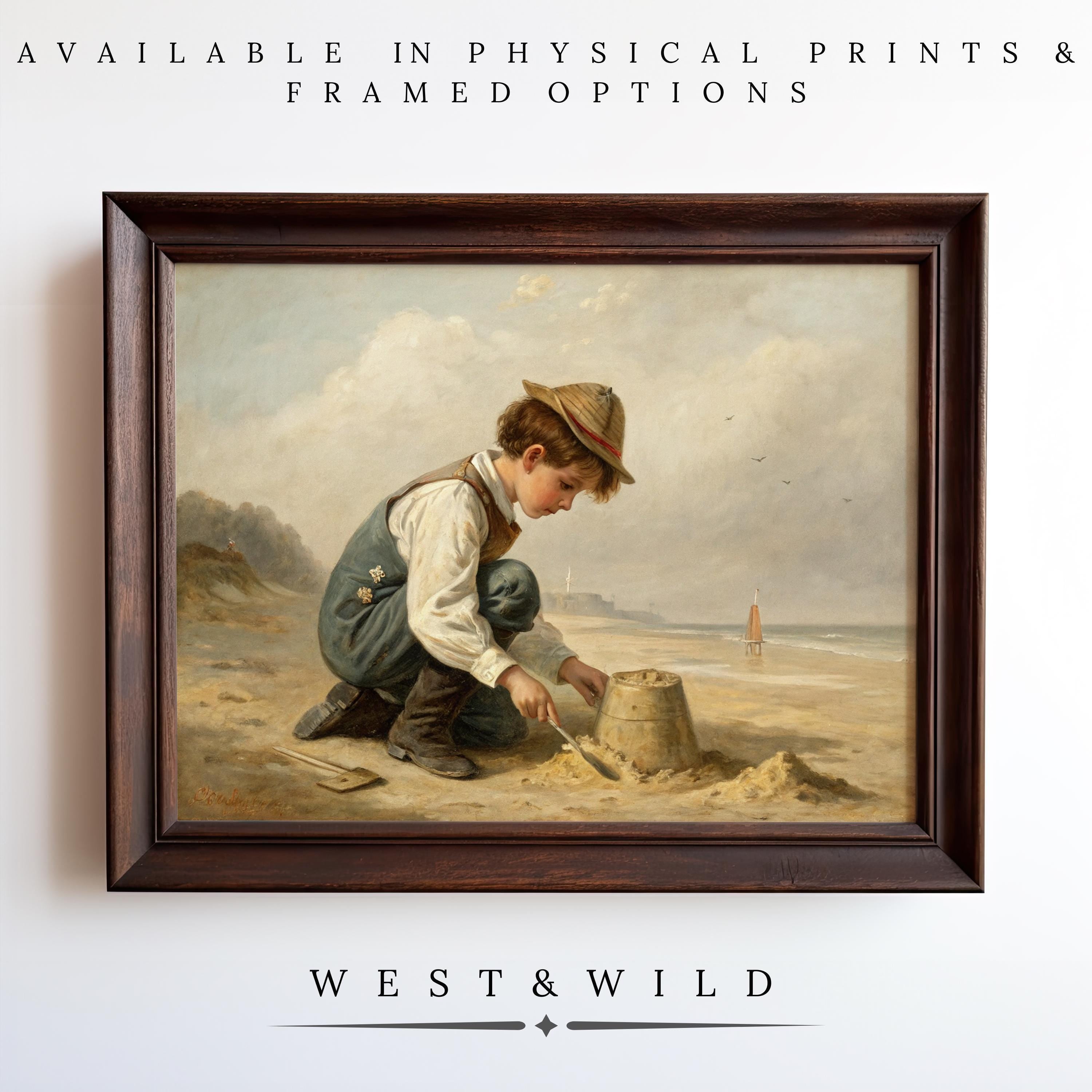 A framed "Boy At Beach Painting – Vintage Nursery Art | Antique Style Artwork Print" shows a young boy building a sandcastle, displayed on a white wall. Available as archival quality prints & framed art. West & Wild.