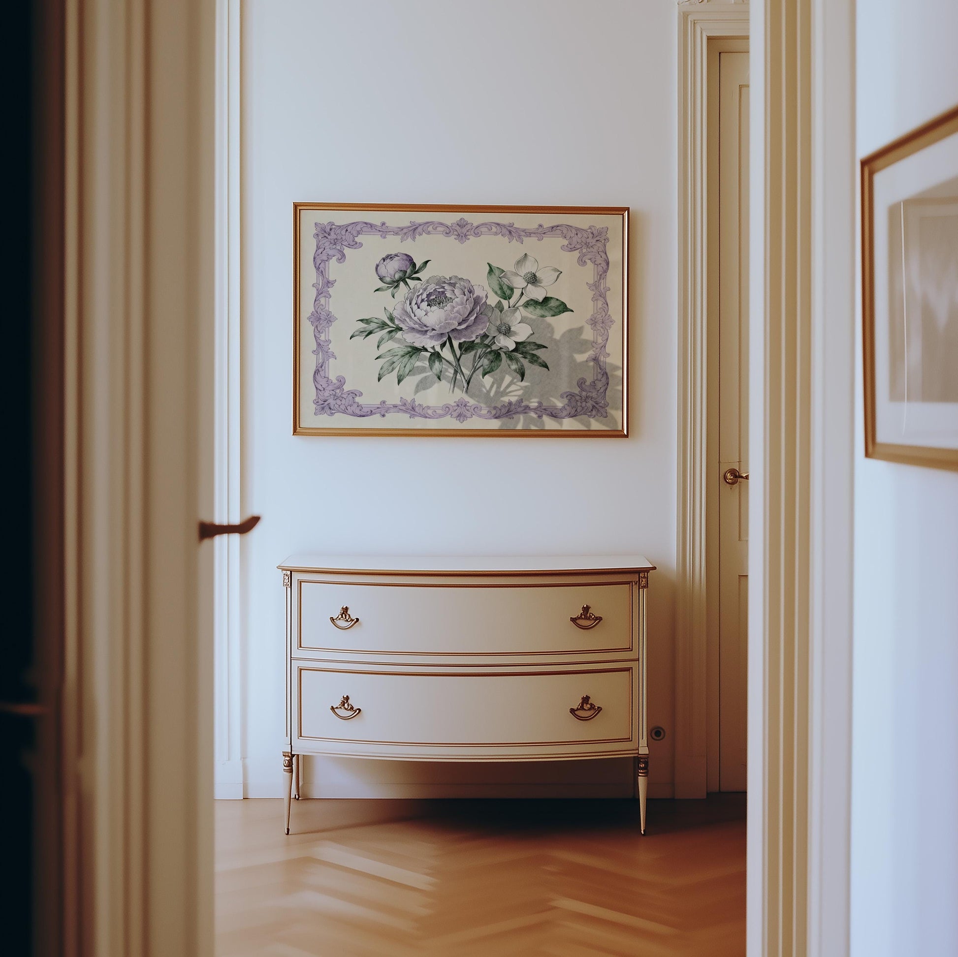 a hallway with a white dresser and a framed floral artwork hanging on the wall above it.