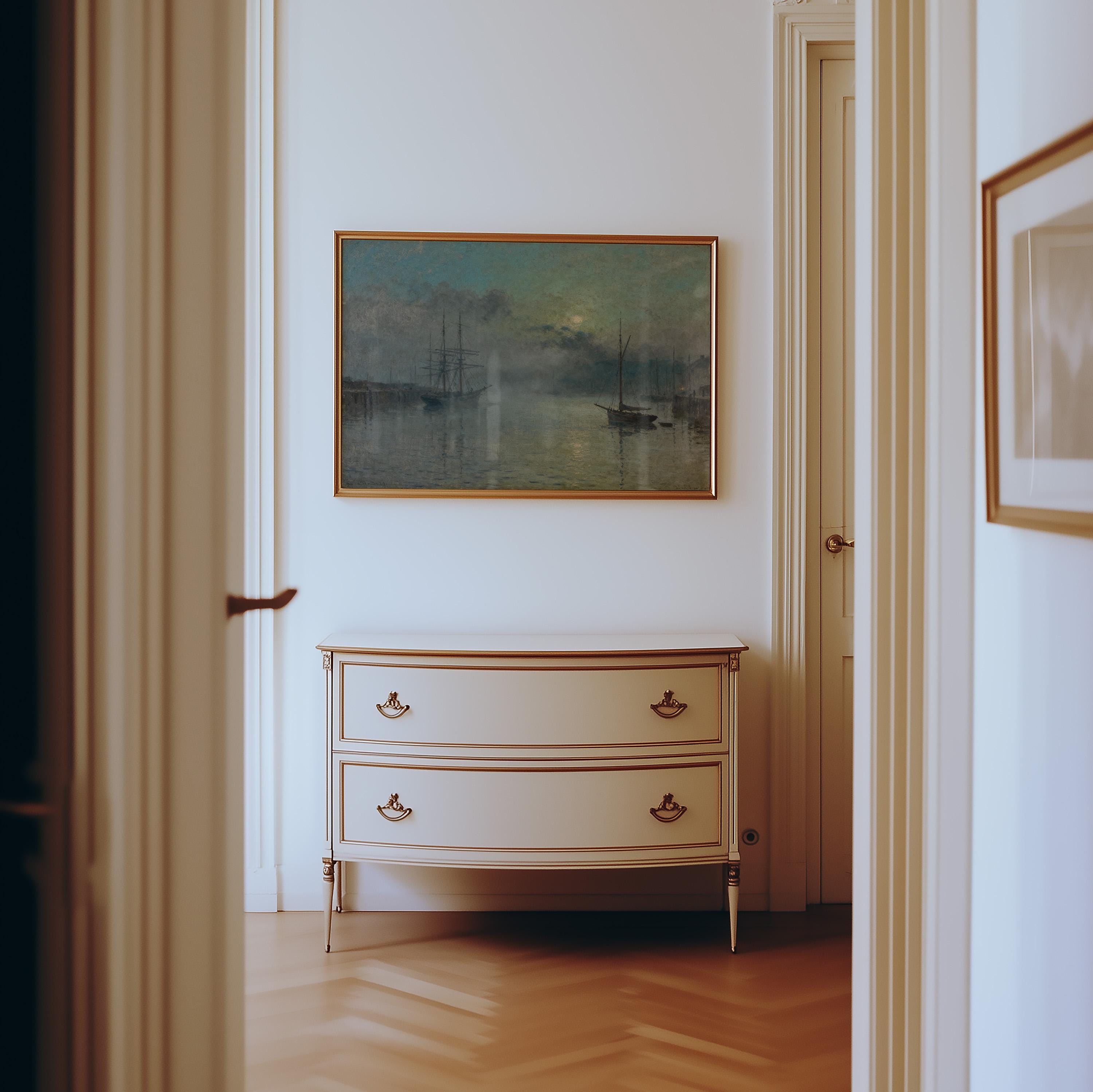 a hallway with a white dresser and a painting hanging on the wall.