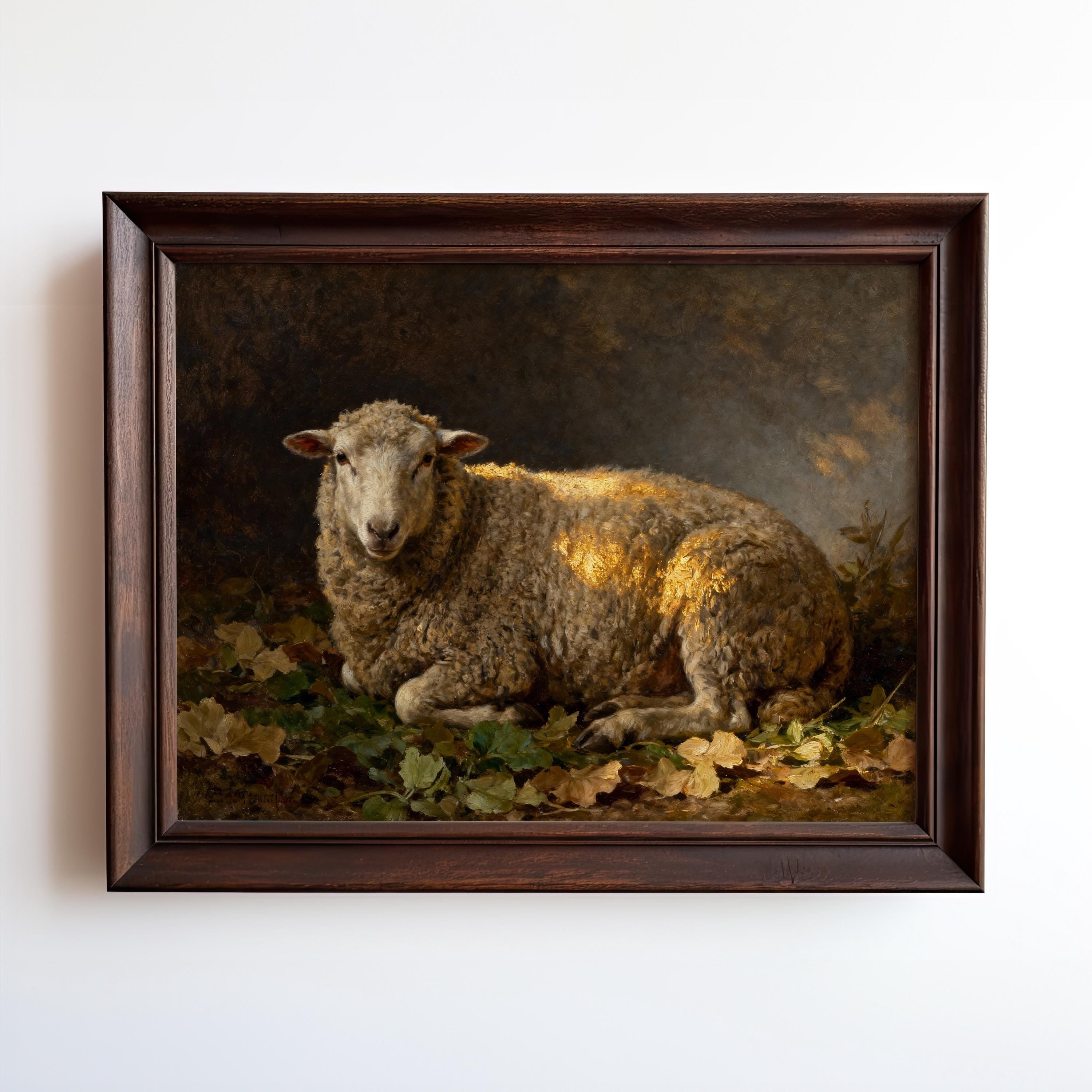 A framed Resting Sheep Art Print – Vintage Farmhouse Wall Art With Warm Earth Tones from West & Wild brings timeless charm to your space, featuring a sheep amid autumn leaves captured in soft, warm light.