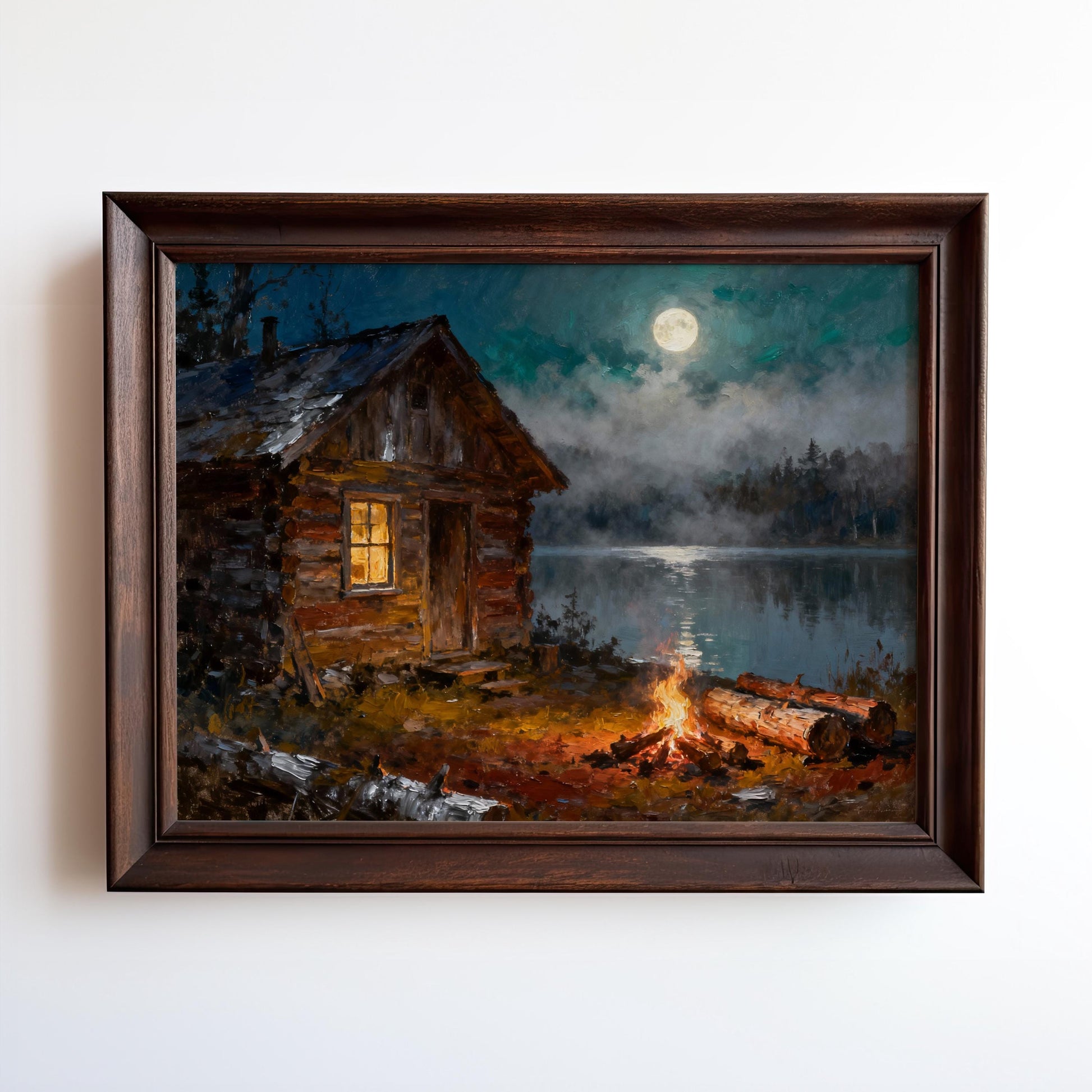 A framed Vintage Log Cabin Print featuring a rustic cabin by a moonlit lake, glowing windows, campfire, nearby logs, and misty water—perfect rustic art for your space.