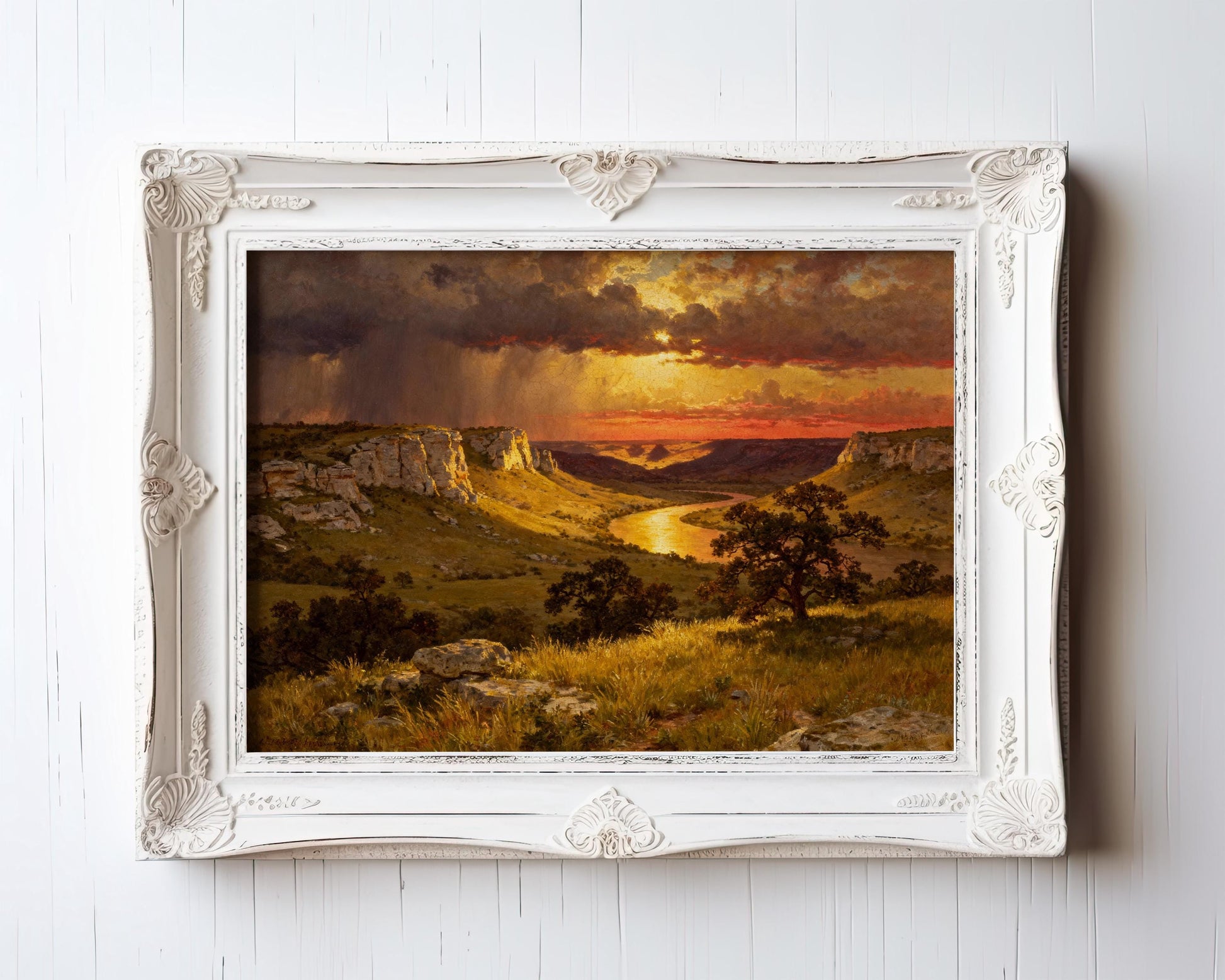 The image is a framed painting depicting a scenic landscape with a dramatic sunset over a mountainous terrain.