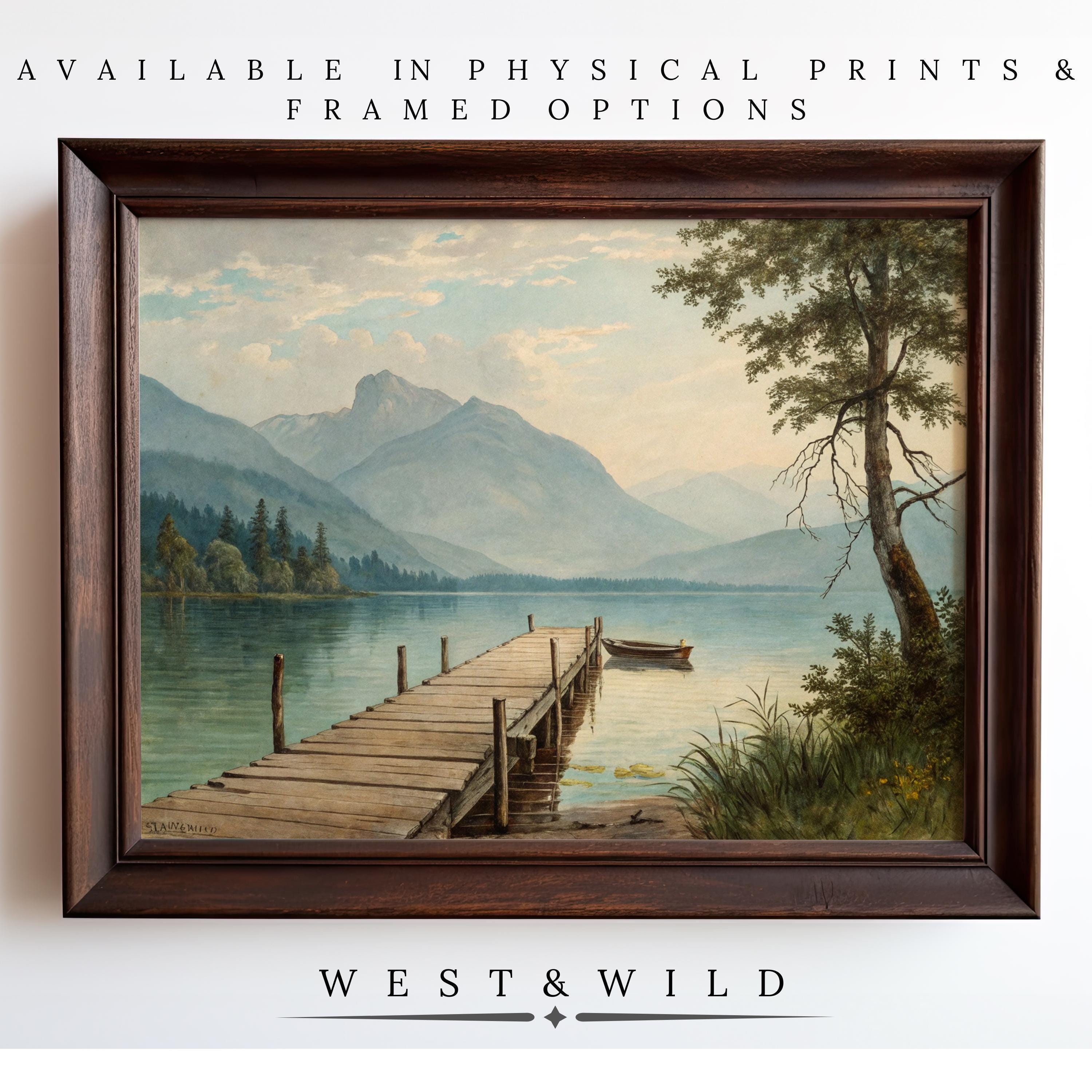 Mountain Lake Wall Art – Vintage lake painting with canoe dock and rustic scenery. Available as archival quality vintage art prints or framed art from the West & Wild Art Archive.