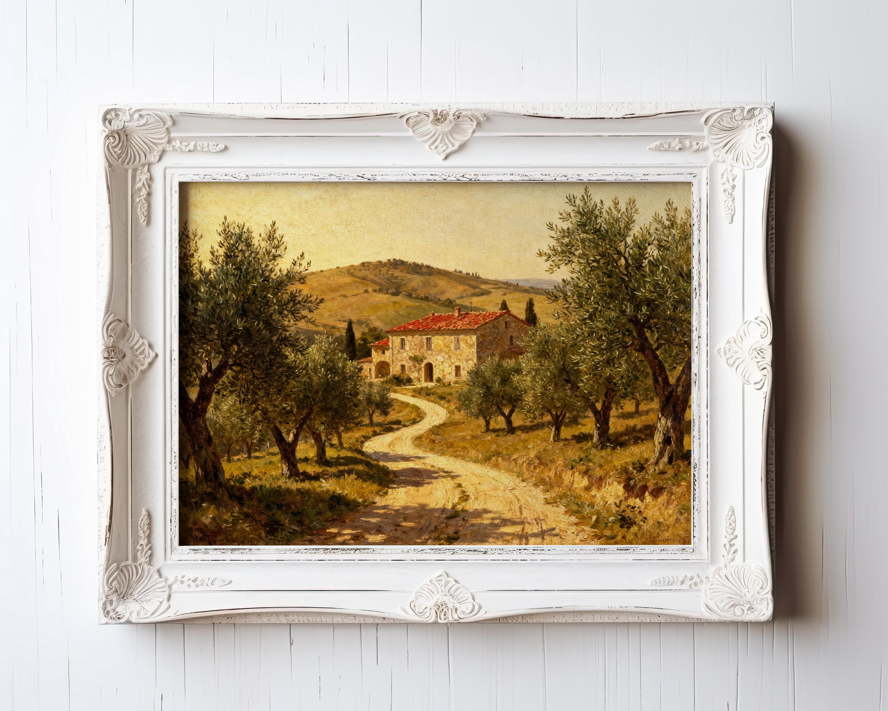 A framed Tuscan Farmhouse Print—Vintage Olive Tree Art with rolling hills and a country house with a red roof—hangs on a white wall. Archival quality ensures this vintage art print’s lasting beauty as part of your decor.
