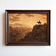 Etching-style print of a cowboy on horseback silhouetted against a sunrise canyon